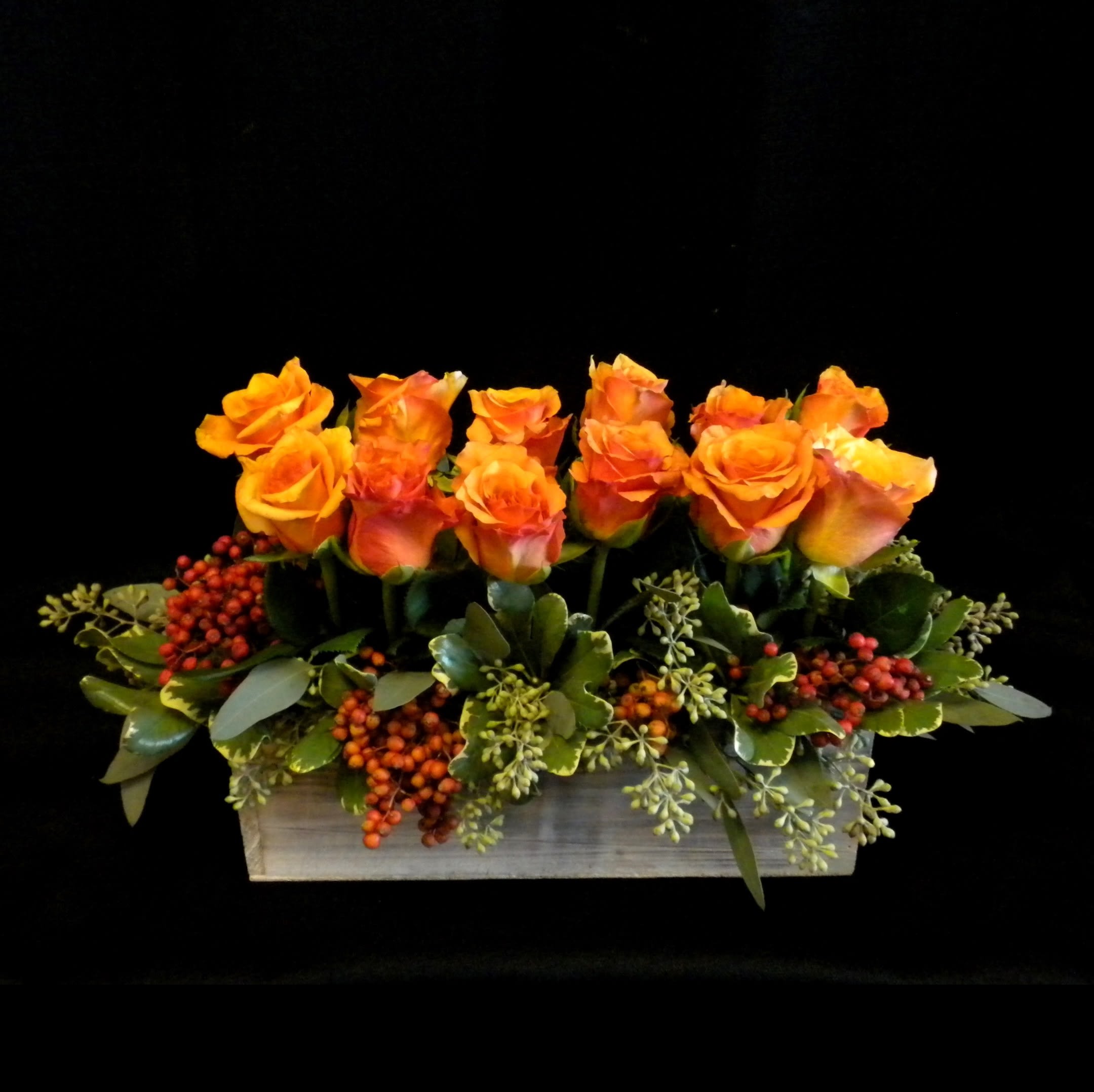 Southern Comfort - &quot;Southern Comfort&quot; is a warm and inviting arrangement featuring 1 dozen radiant orange roses paired with lush greenery and seasonal berries, all styled in a rustic wooden box. A perfect touch of charm and elegance, this design brings the rich, cozy spirit of the South to any occasion in Danville, CA. 