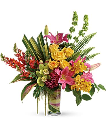 Pretty Paradise Bouquet - Take a tropical getaway, without ever leaving home! Inspired by the shades of a tropical sunset, this paradise of bright colors and rainforest textures is a dramatic experience for the senses! This pretty bouquet features dark pink hydrangea, green cymbidium orchids, yellow mokara orchids, yellow roses, hot pink oriental lilies, orange snapdragons, bells of Ireland, hanging green amaranthus, huckleberry, sword fern, hala leaves, ti leaves, bear grass, and lemon leaf. Delivered in a clear glass vase.