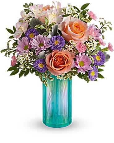 Teleflora's Aqua Rose Bouquet - Dream a little dream...then send it to someone special as colorful spring blooms in a shimmering aqua glass vase! Peach roses, pink alstroemeria, miniature pink carnations, lavender matsumoto asters and lavender daisy spray chrysanthemums are arranged with white waxflower, dusty miller and pitta negra. Delivered in an Iridescent Dream Vase.