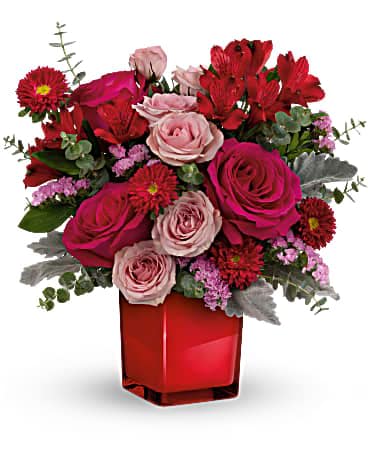 Teleflora's Loving Bunch Bouquet - Bright and bold, this gorgeous gift of hot pink roses in a crimson glass cube is sure to make them feel loved This bold bouquet features hot pink roses, pink spray roses, red alstroemeria, red matsumoto asters, pink sinuata statice, dusty miller and spiral eucalyptus. Delivered in a Color Splash Cube.