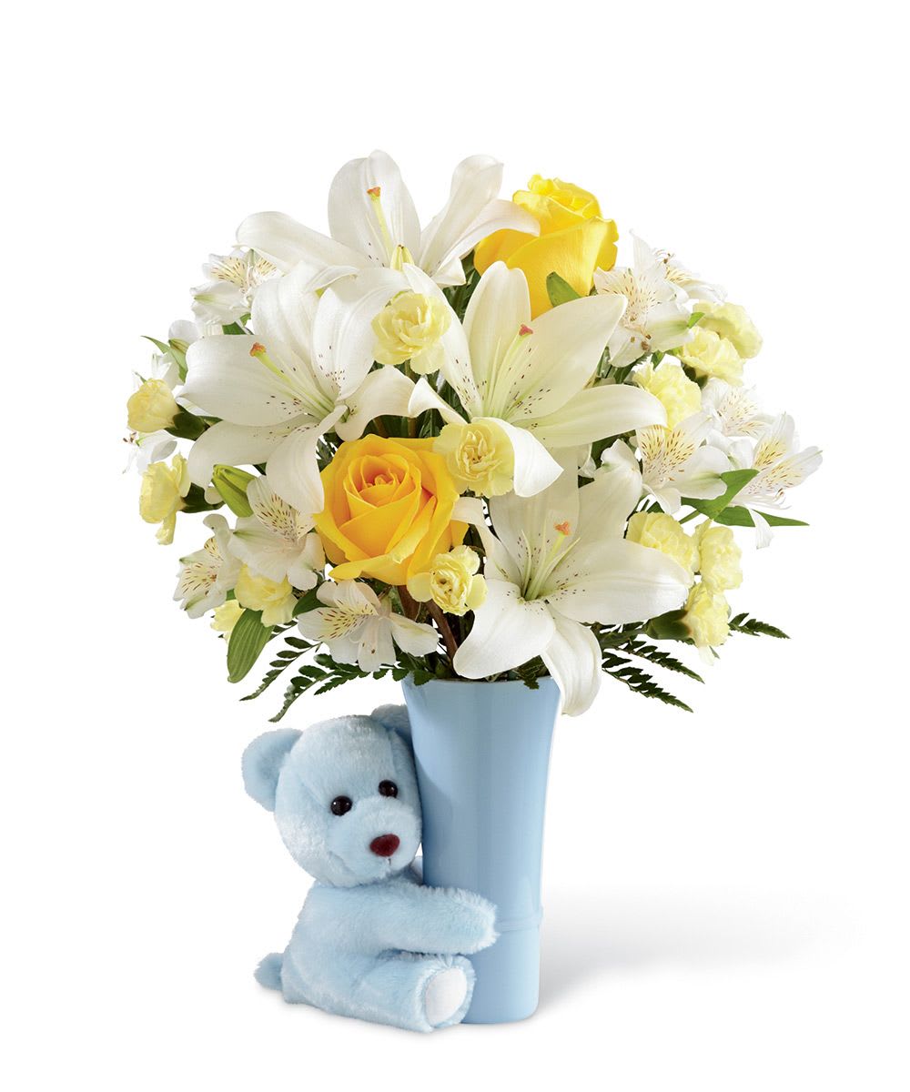 It's a Boy - Fresh lilies, roses, carnations and a plush bear are the the heartbeat of this beautiful floral arrangement specifically for the beautiful bouncing baby boy arrival.  