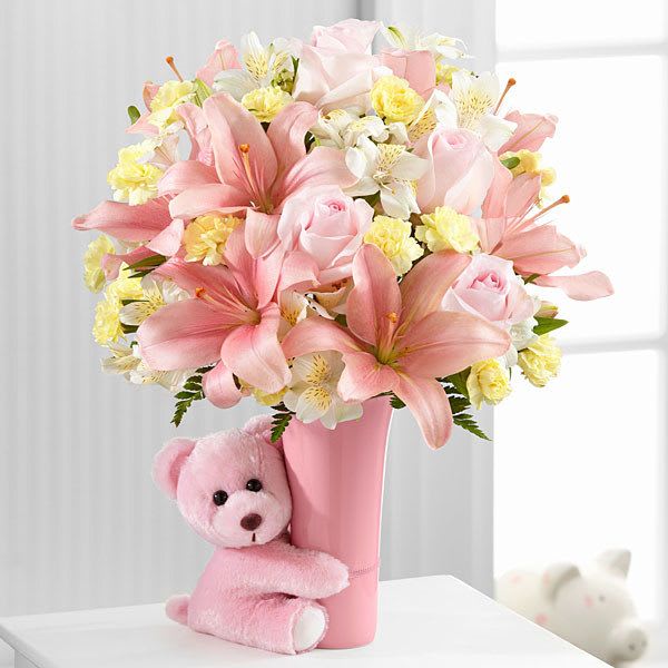 It's a Girl - Lilies, Roses, Mini Carnations and a plush bear are the heartbeat of this beautiful arrangement.  Perfect for the new arrival of a beautiful baby girl.
