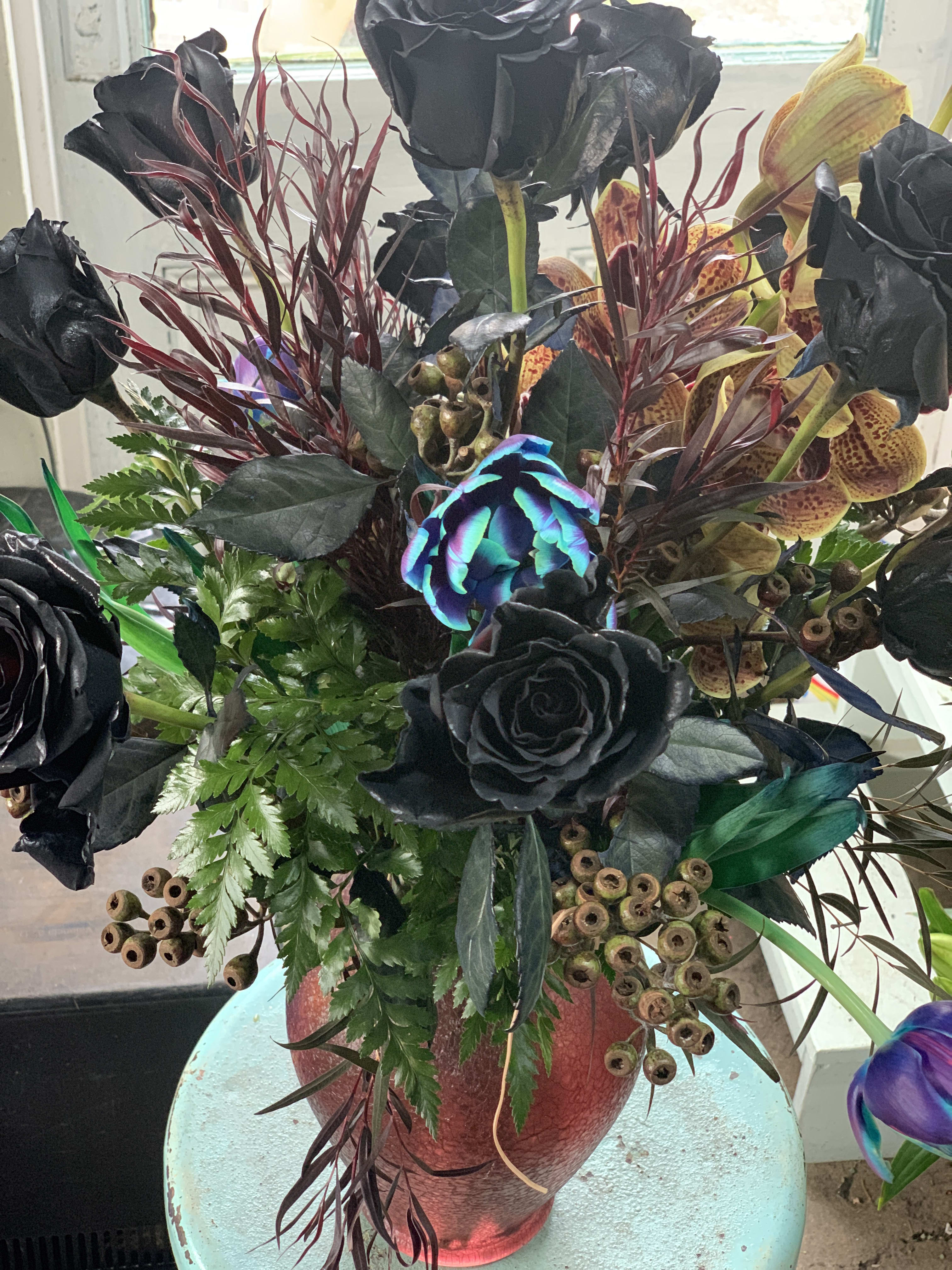 Gothic Grandeur Gothic Grandeur - Beauty and florals goes hand in hand even with the most unconventional preferences. This dark beauty is gorgeous, impressive and a joy to create because nature is simply beautiful! Please allow for additional ordering time for dyed roses and unique curated selections.