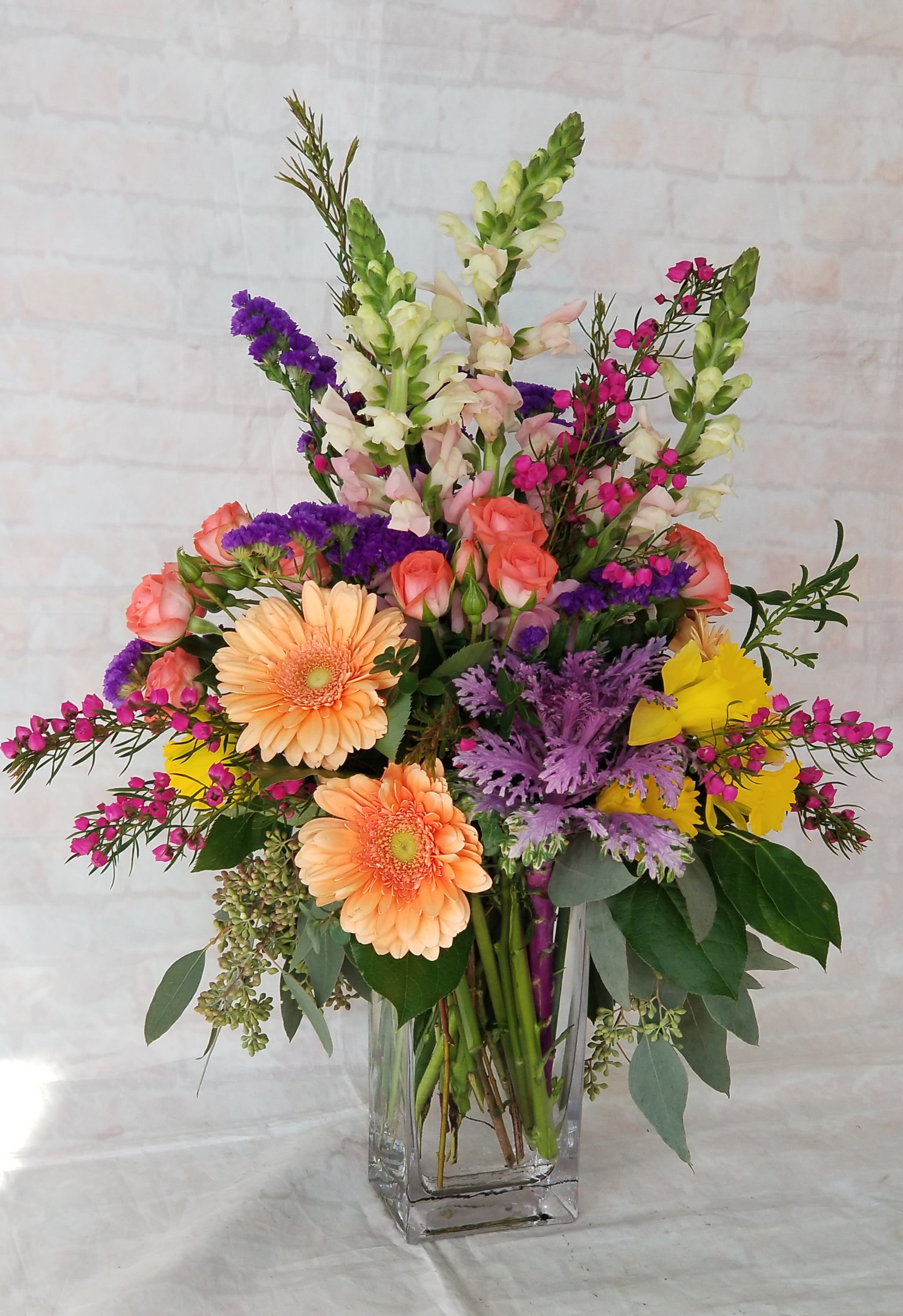 Spring Happiness Spring Happiness - Select this bright mix of gerbera daisies, snapdragons, and spray roses in a rectangular vase.