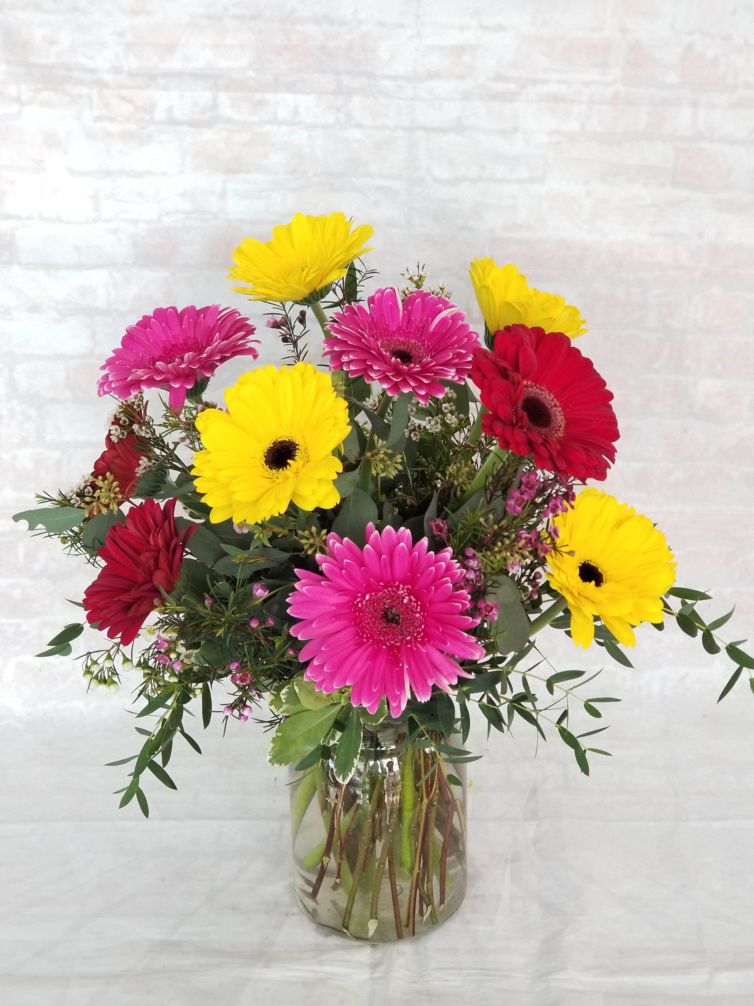 Simply Gerbs Simply Gerbs - Select this bright and fun arrangement of gerbera daisies in a clear glass vase. Colors may vary. Call for specific availability or add specific color request to special instructions and we will do our best to fulfill.