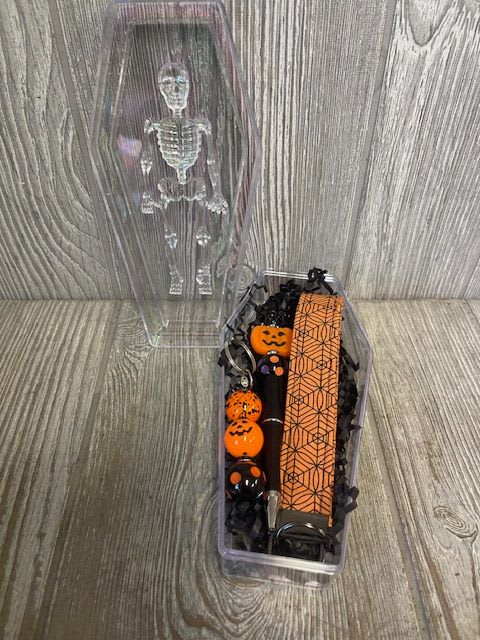 Halloween Surprise Box - Coffin shaped surprise box, with a Halloween themed wrist strap, keychain and pen. 