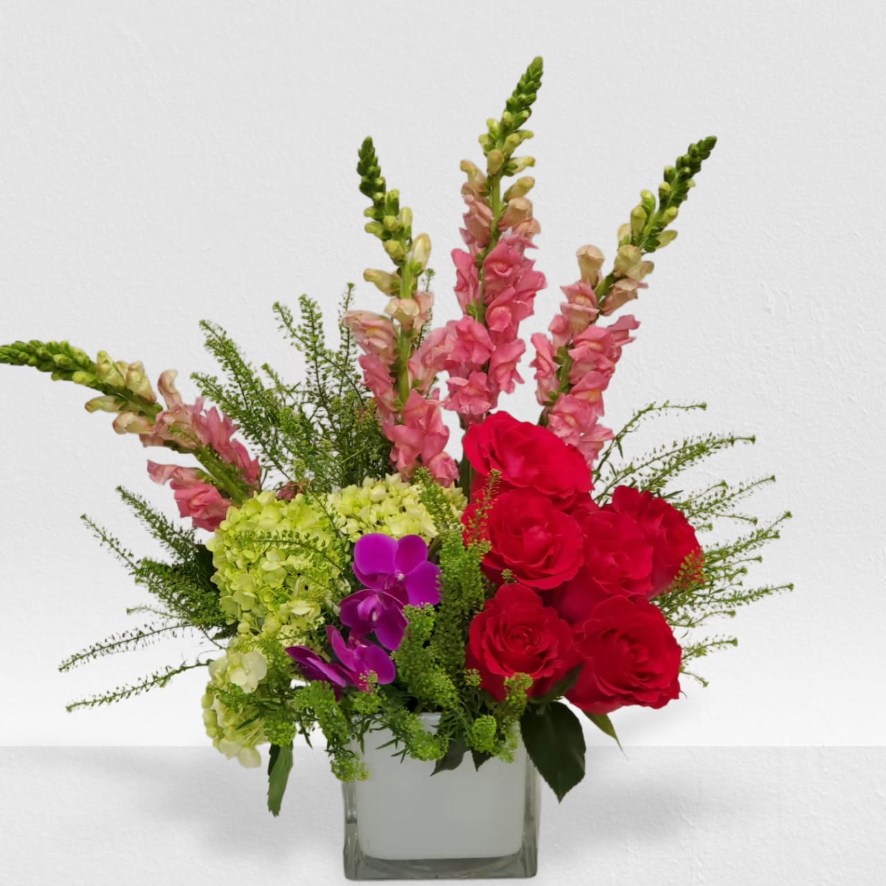 Take Me Away Take Me Away - Escape to paradise with this lush and vibrant bouquet. This arrangement contains Cymbidium Orchids, Bells of Ireland, Snapdragon, Roses, and Button Mums. This is the perfect gift for a birthday, congratulations, or to celebrate new beginnings.
