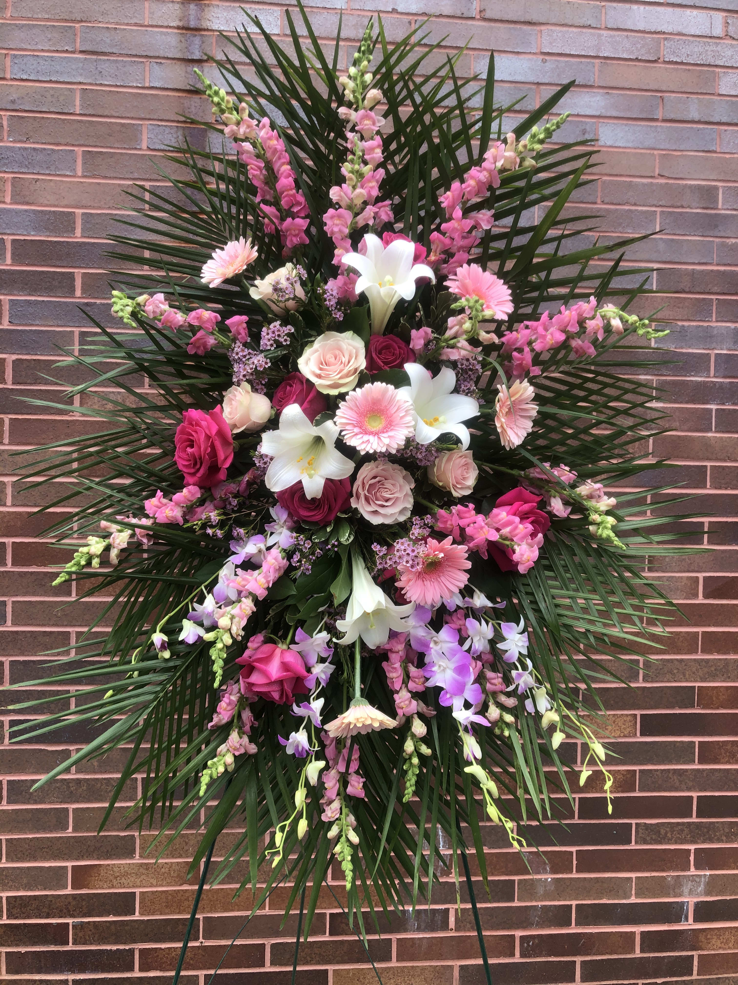 Touch of Pink Spray Touch of Pink Spray - Lilies, Snapdragon, Assorted Roses, Gerbera Daisies, Dendrobium Orchods, Assorted Fancy Greens