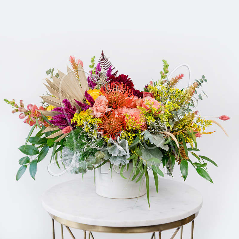 Seasonal Medium Arrangement - Seasonal flowers artfully combined to create an elegant yet wild arrangement showcasing the season's best colors. Amazing mix of fresh and dried flowers featured in our Ceramic Pottery Vase.