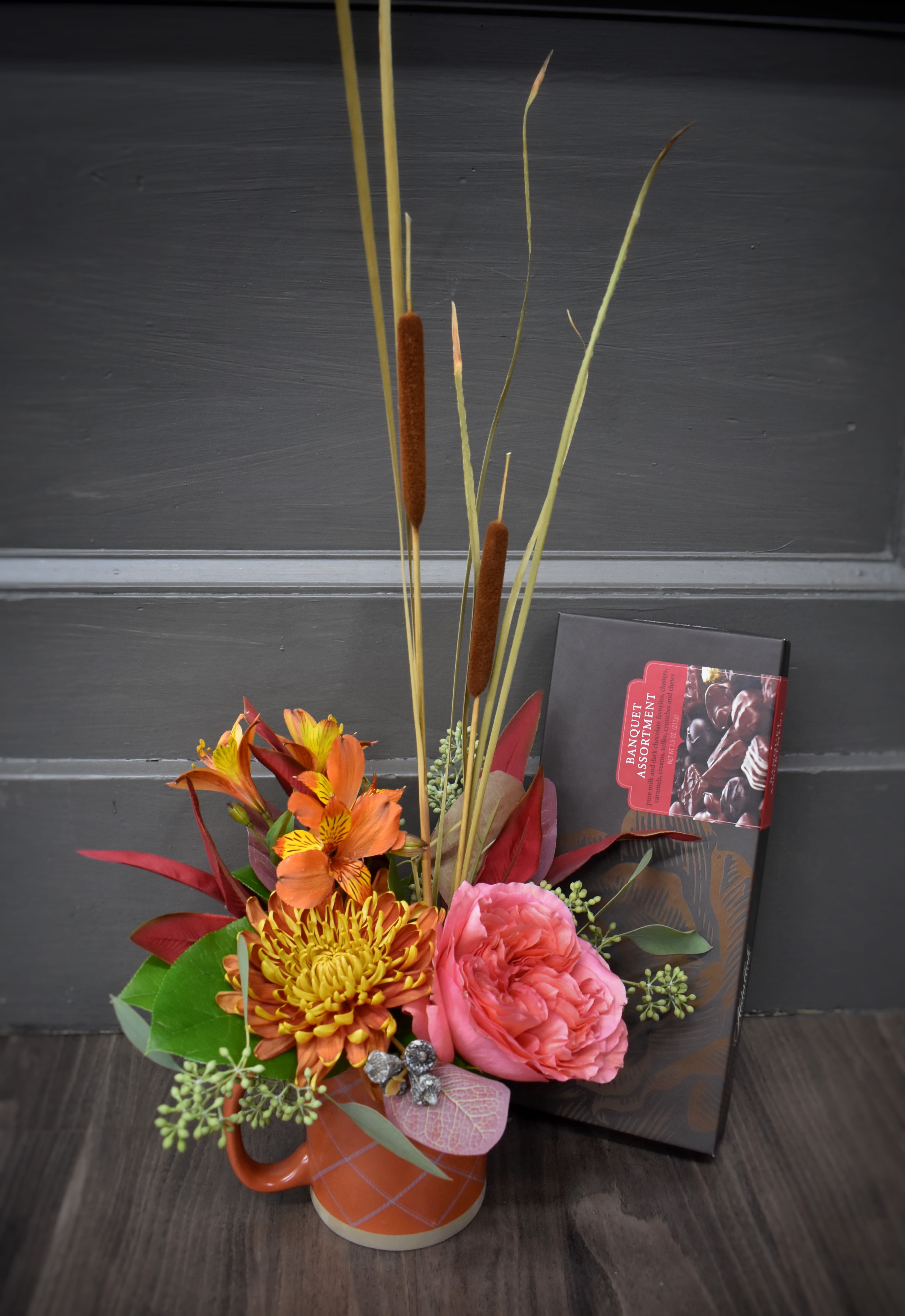 Mug-nificent Fall Mug-nificent Fall - Pour yourself a cup of autumn! A keepsake mug filled with fall-colored flowers paired with rich Abdallah chocolates.