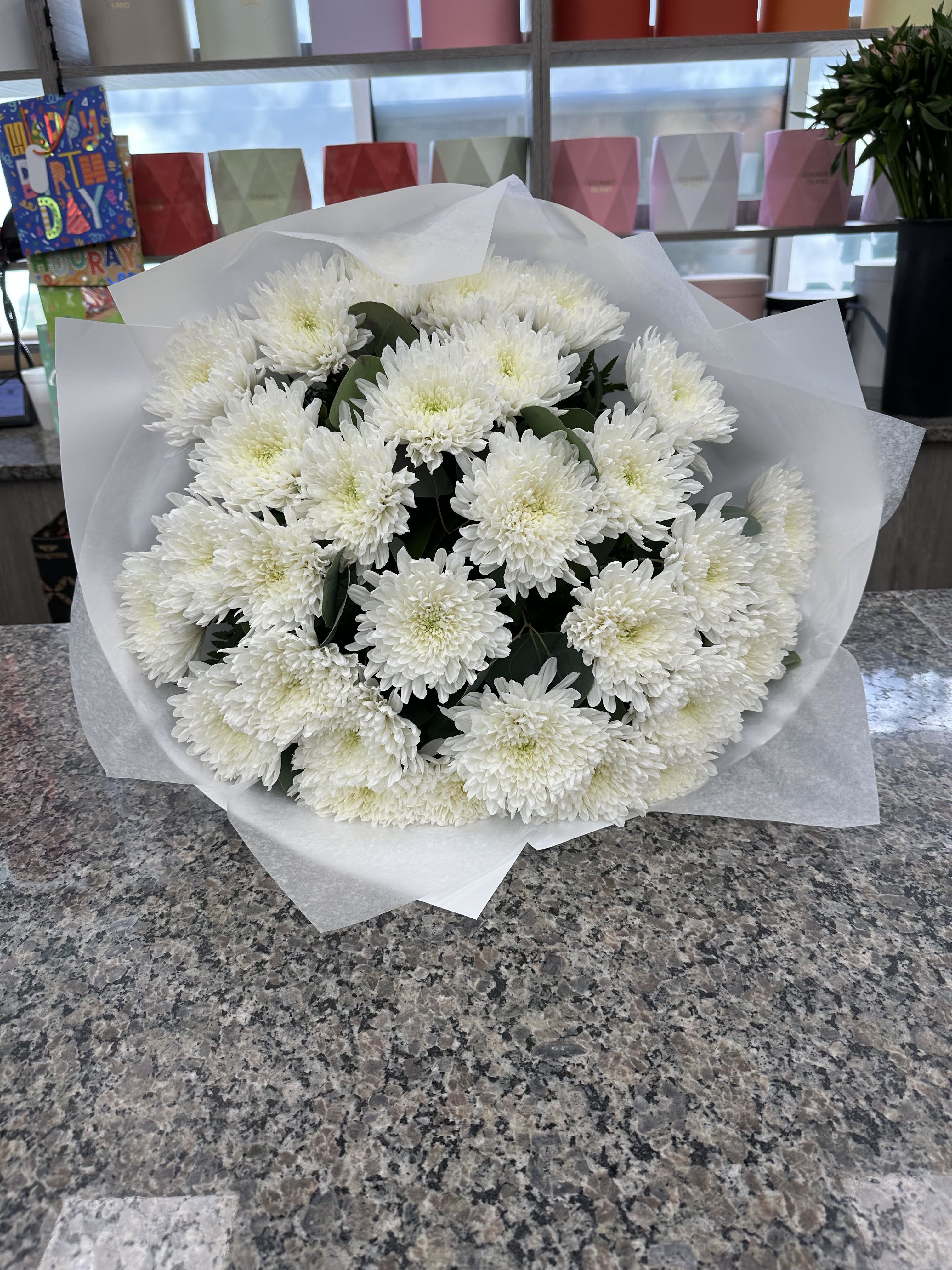 Amelia - Hand-wrapped bouquet of fresh white mums. A timeless and elegant choice, available in three sizes: 15, 21, or 30 stems.