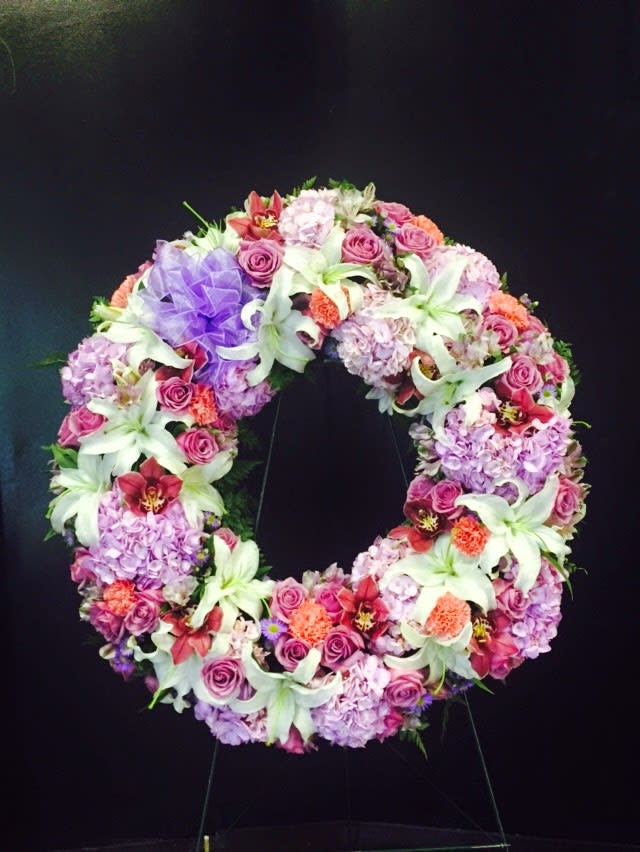  full of peace sympathy wreath - a beautiful wreath with pink hydrengeas, cymbidium orchids, purple roses, white lilies  and orange carnetions