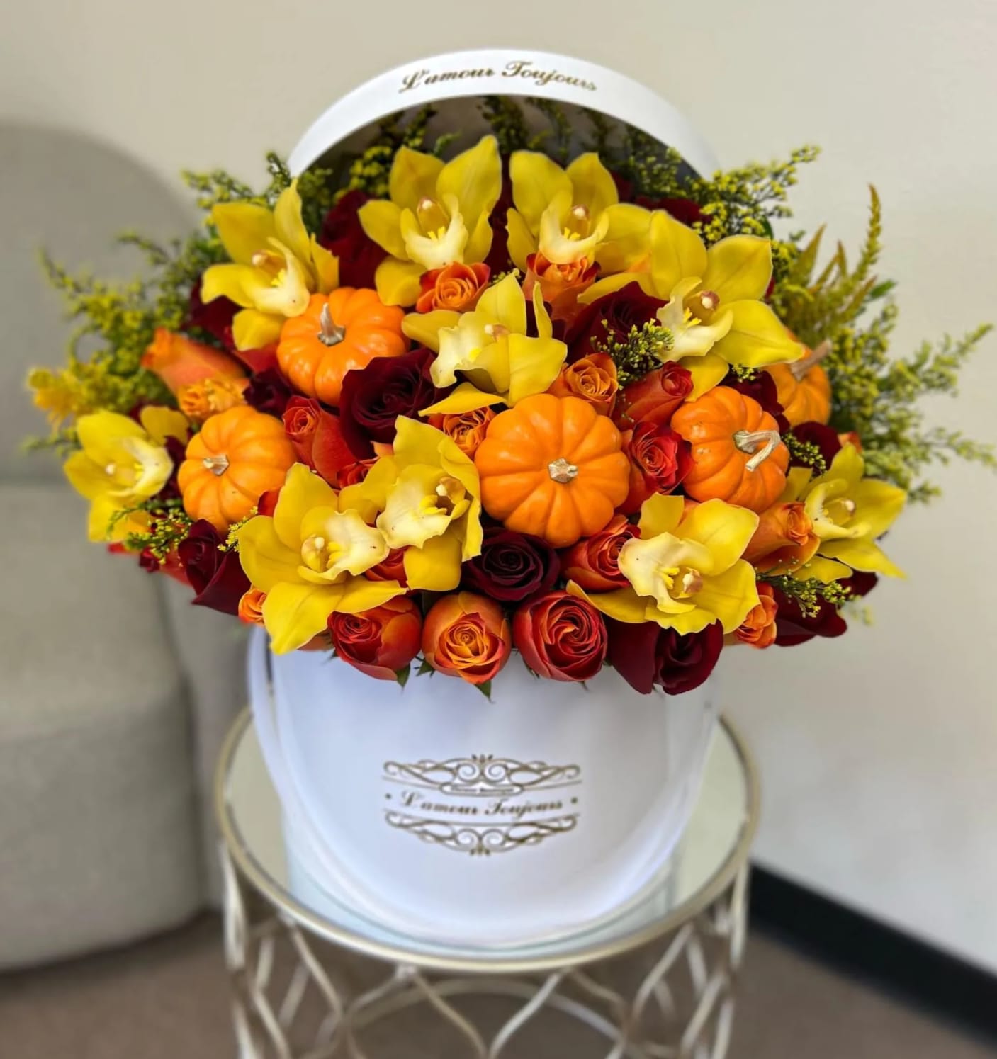 Fall Symphony Signature Box - Roses, cymbidium orchids and miniature pumpkins mix in our Signature Box