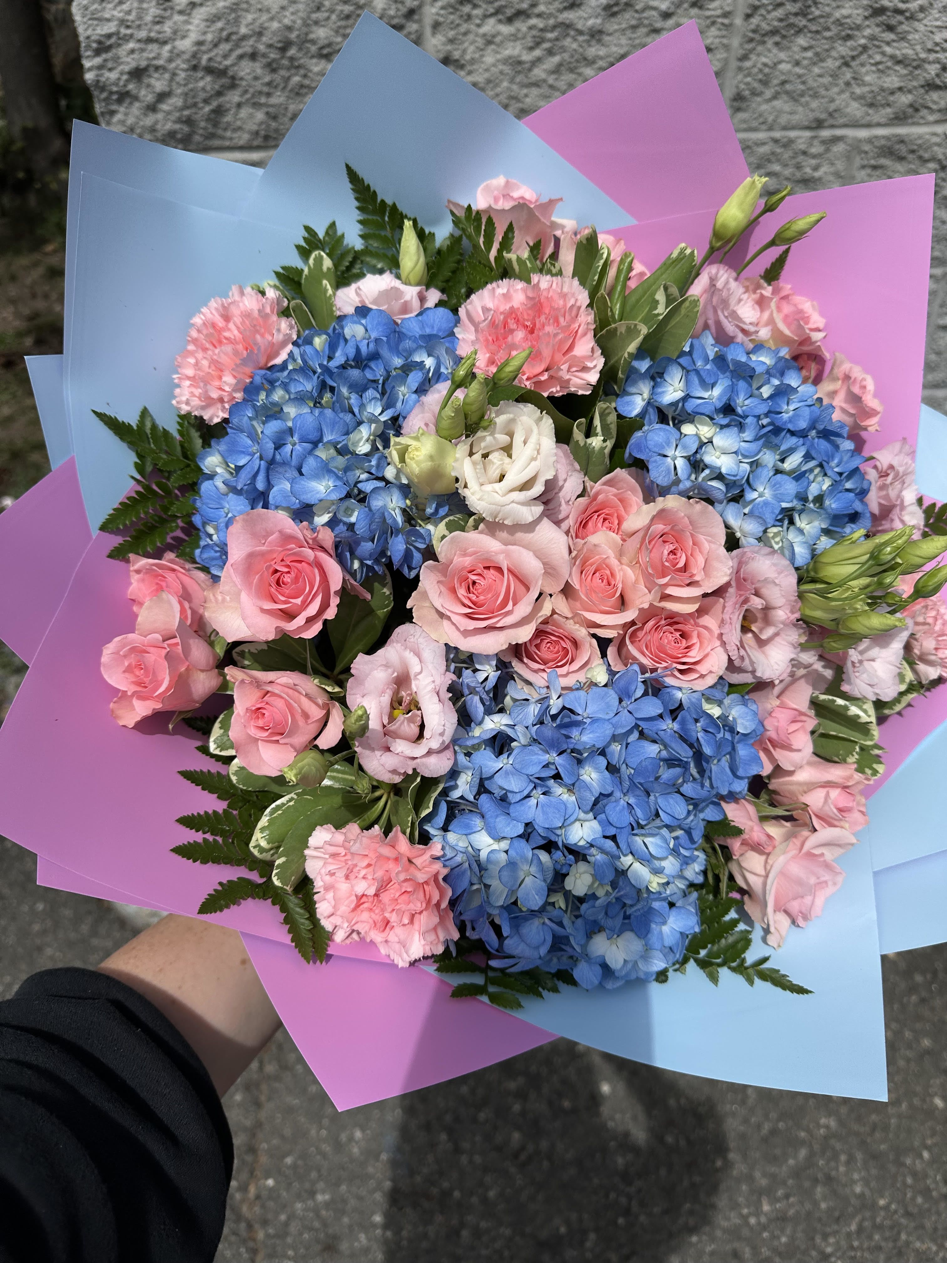 It's a Girl/ It's a Boy - Pink and Blue Hand-Wrapped Bouquet- A charming mix of blooms in soft pink and blue, the perfect gift to celebrate both It's a Boy and It's a Girl occasions.
