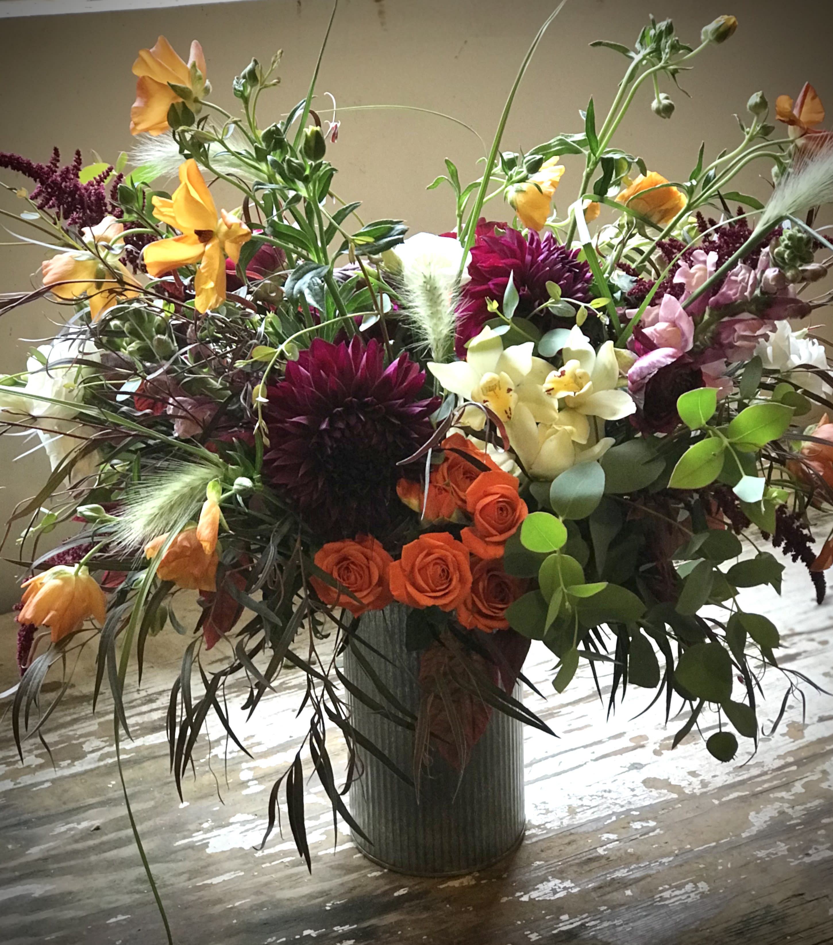Feels Like Fall-Seasonal  - Seasonal Fall arrangement…a variety of Autumn colors and textures gathered with mixed seasonal greens. 