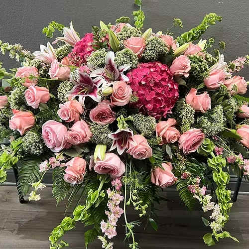 Casket Piece Forever Remembered - A casket piece pink in color with hydrangeas, cala lilies, roses and filler.