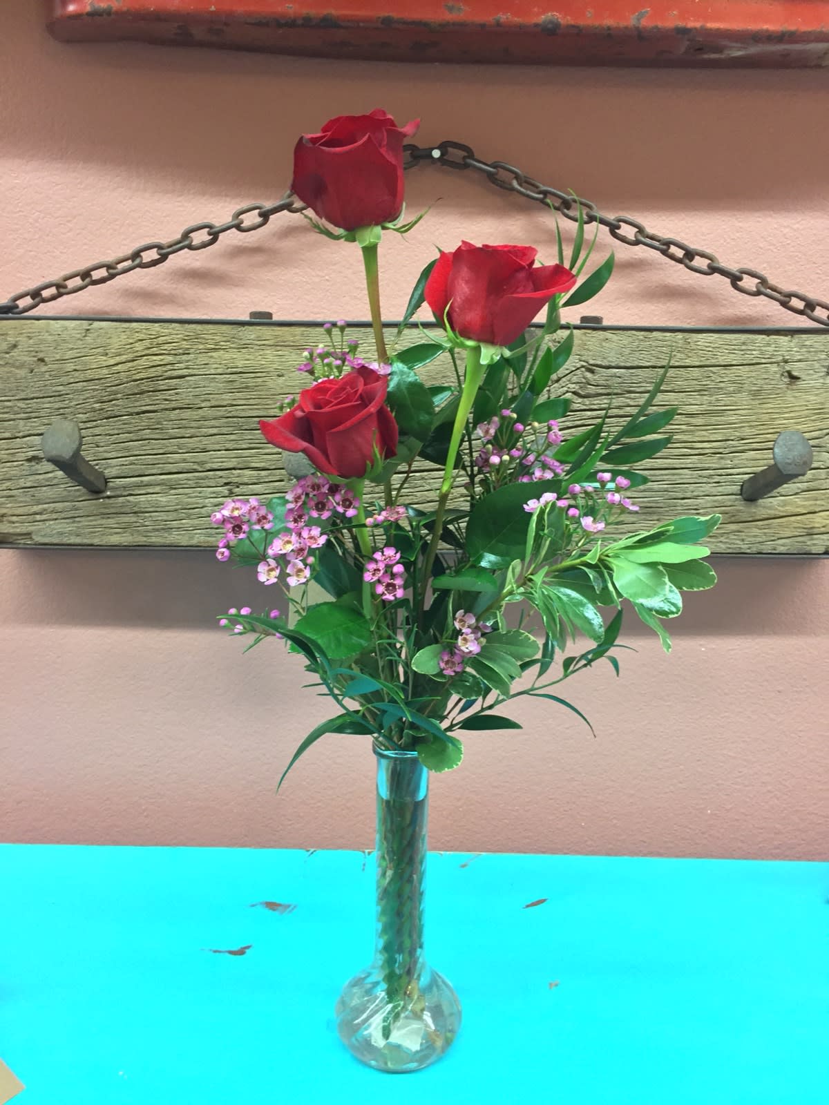 Red Rose Trio - Sometimes a simple statement is best. Three Red roses, arranged beautifully with greens in a glass vase. Delight her with an upgrade to deluxe and the arrangement will include luxurious Alstroemeria lilies. Astound her with fuller arrangement in Premium by adding chrysanthemums.