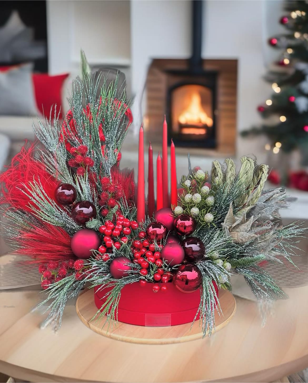 Christmas day centerpiece.  - This holiday centerpiece features a stunning arrangement of red ornaments,  candles, and lush green fir branches, creating a vibrant and festive atmosphere. The bright red spheres symbolize joy and celebration, representing prosperity, the warmth of love and the spirit of giving during the holiday season. The candles add a touch of elegance and warmth, symbolizing flickering stars , hope and the light that brings people together. The green fir branches signify resilience and life, reminding us of nature's beauty and the importance of family gatherings. Together, these elements create a harmonious and inviting centerpiece that embodies the essence of the holidays, making it a perfect focal point for festive gatherings and celebrations.