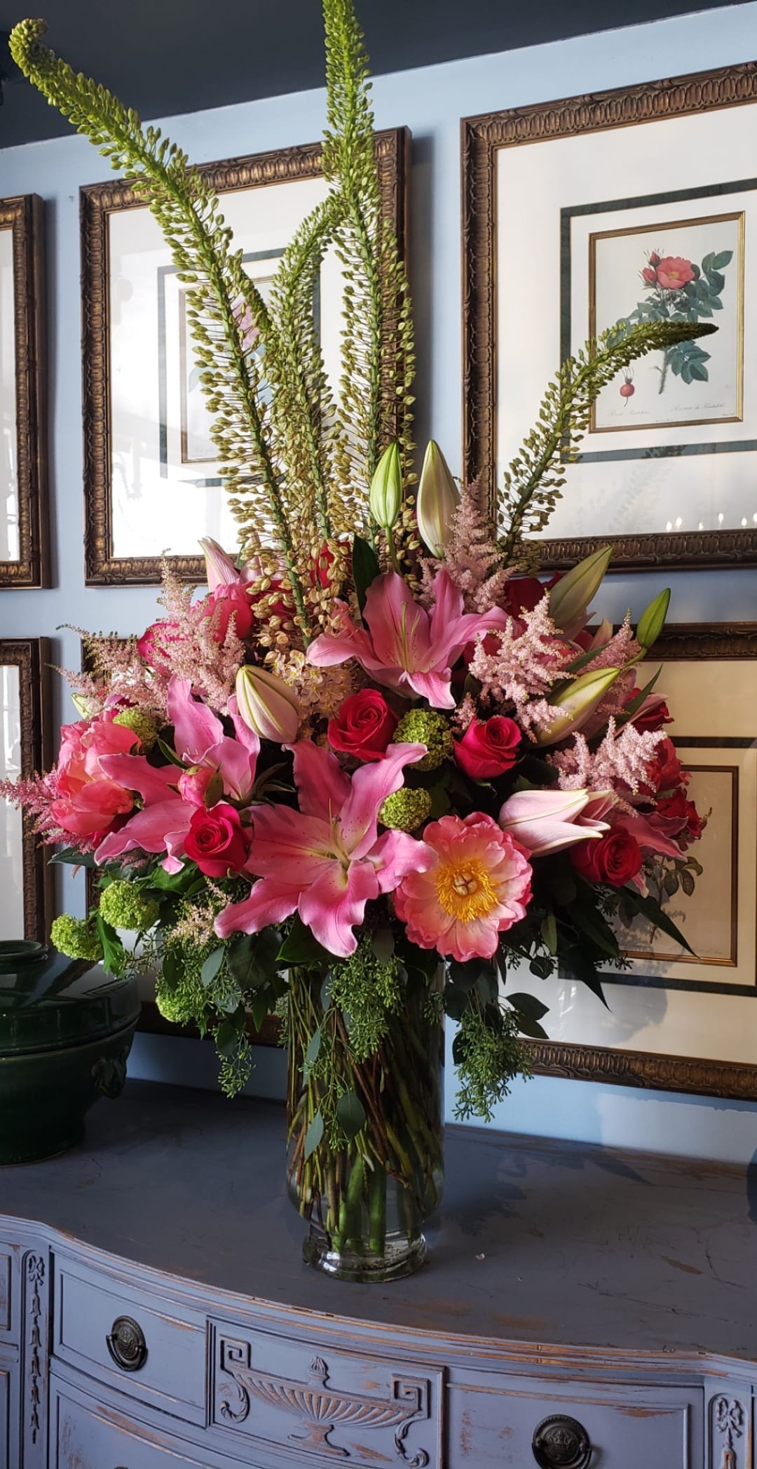 California Dreaming - Elegant large pedestal vase filled with magnificent oriental pink lilies, hot pink roses, pink peony, eremurus, &amp; green viburnum complimented with light pink astilbe.  **color and container may vary**