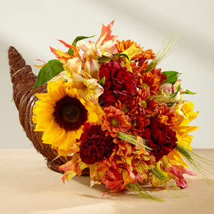 Fall Harvest Cornucopia Fall Harvest Cornucopia - "Set the Table" with this traditional cornucopia.  Approx. 12 inches high.  Upgrades include roses & additional flowers. Due to current market conditions, substitutions will happen.