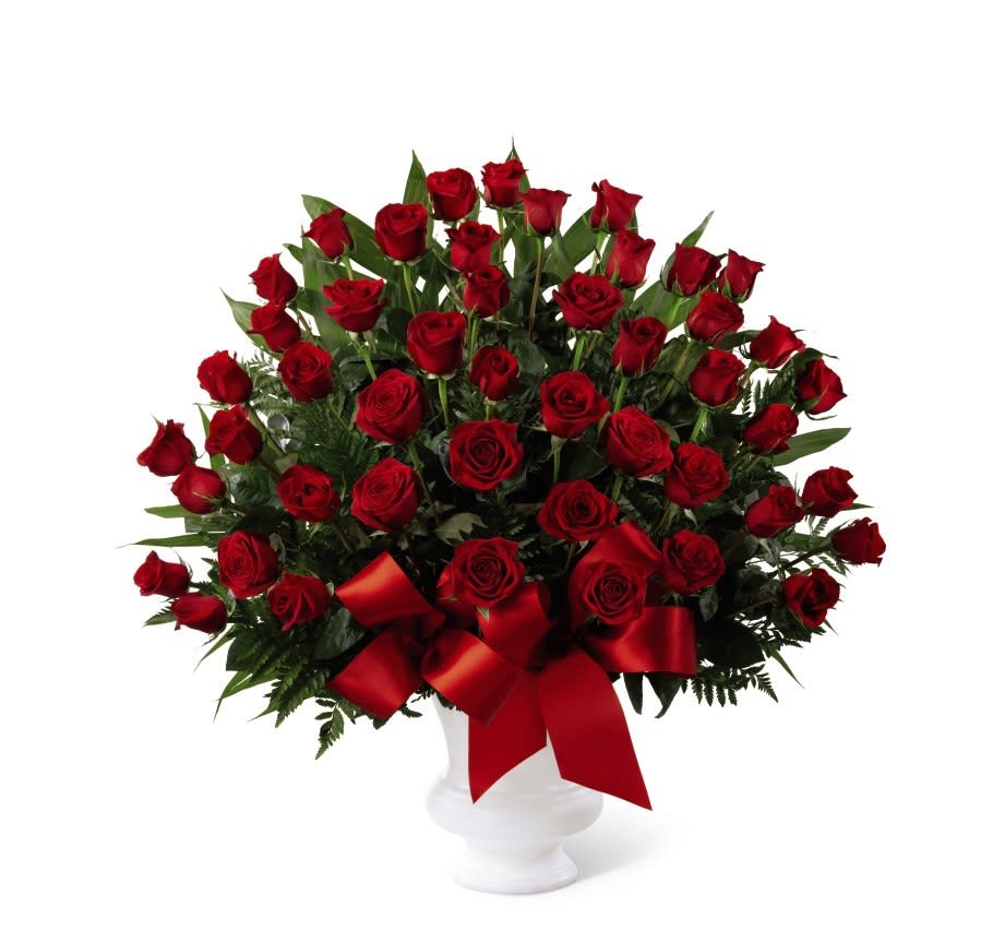 TLSP The Soul of Splendor Arrangement - The Soul's Splendor Arrangement is a rich display of the love shared throughout the life of the deceased. Brilliant red roses are elegantly displayed in a white designer plastic urn and accented with lush greens and red satin ribbon to create a beautiful tribute to honor your special relationship. GOOD arrangement includes 36 roses. BETTER arrangement includes 48 roses. BEST arrangement includes 60 roses.  Your purchase includes a complimentary personalized gift message.