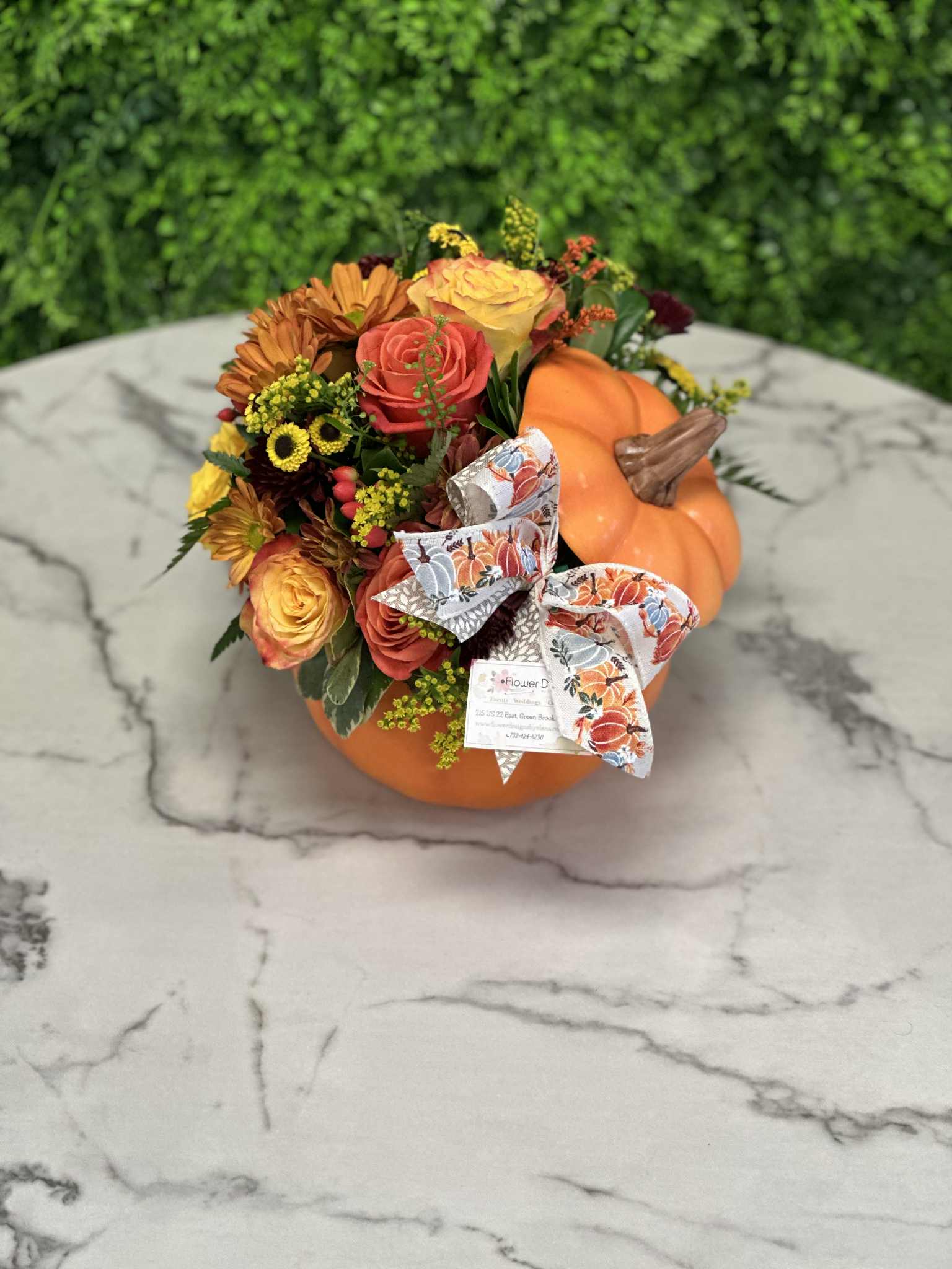 Pumpkin Centerpiece - Combine your Flower Power with Pumpkin Power with this wonderful, dare we say “powerful,” seasonal arrangement. Housed in a ceramic pumpkin vase, you will surely “fall” in love with this collection of fall flowers this fall. Pumpkin with lid