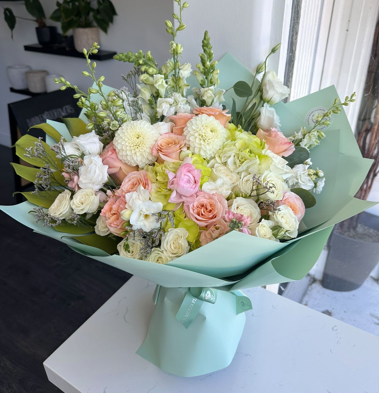 Lime shade Lime shade - Fresh, bright, and uplifting — the Lime Shade bouquet blends soft pastels with crisp white blooms, all wrapped in a chic mint-green shade. Perfect for birthdays, celebrations, or simply bringing a breath of freshness into any space.  Key Features:     •    Styled in a modern mint-green wrap for a refreshing look     •    Finished with a signature ribbon for an elegant touch     •    Available in Standard ($149), Deluxe ($199), Premium ($249) sizes     •    A versatile gift that’s both cheerful and sophisticated  VASE NOT INCLUDED