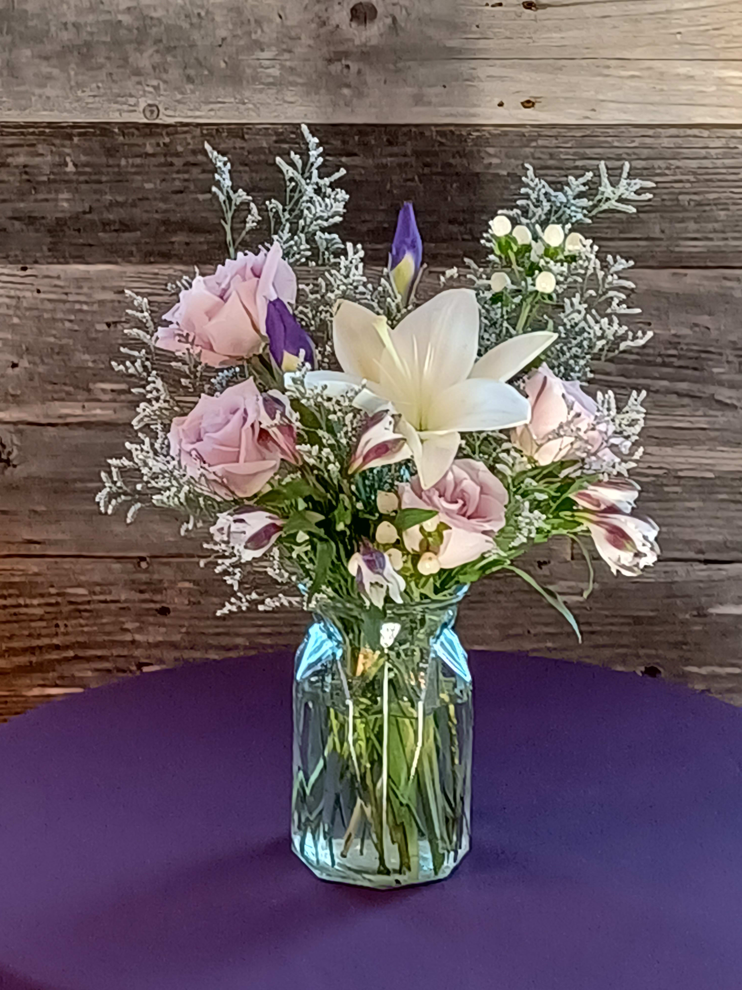 Take My Breath Away - A gorgeous arrangement in a cut-glass type vase. Roses, lilies, iris, and sinesis, with lovely greens and some hypericum berries.