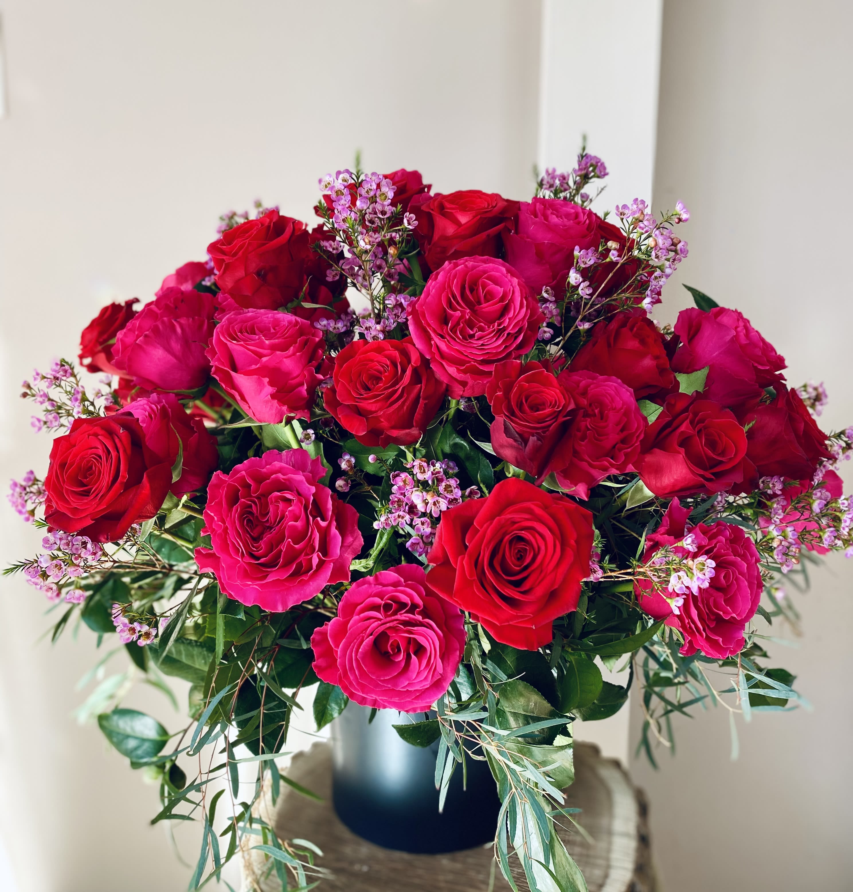 Gather Ye Rosebuds - Inspired by John William Waterhouse's painting called &quot;Gather Ye Rosebuds while ye may&quot; (1908), we made sure that this arrangement has every rose bloom featured at its glory! A mix of 50 (total) gorgeous red and hot pink roses will leave Her smiling!!! Trust us on that!  - 25 red roses - 25 pink roses - filler flower (depending on the seasonal availability) - greenery Arranged in a ceramic vase (color may vary based on availability).   The last picture features J.W. Waterhouse's (1849-1917) painting &quot;Gather Ye Rosebuds while ye may&quot;.