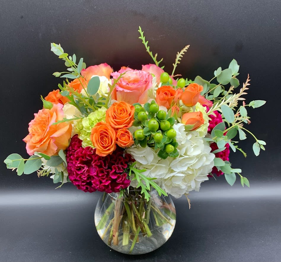BRILLIANT $90/105/120 - Colorful design of hydrangea, roses, spray roses and hypericum berries that is sure to please.  