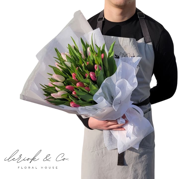 Signature Tulip Bouquet  - Cause some girls are Tulip girls!  For them, our Signature Tulip Bouquet is available as a seasonal product. We will try our best to get your requested colors.  Standard - 20 Tulips *As Pictured* Deluxe - 40 Tulips 