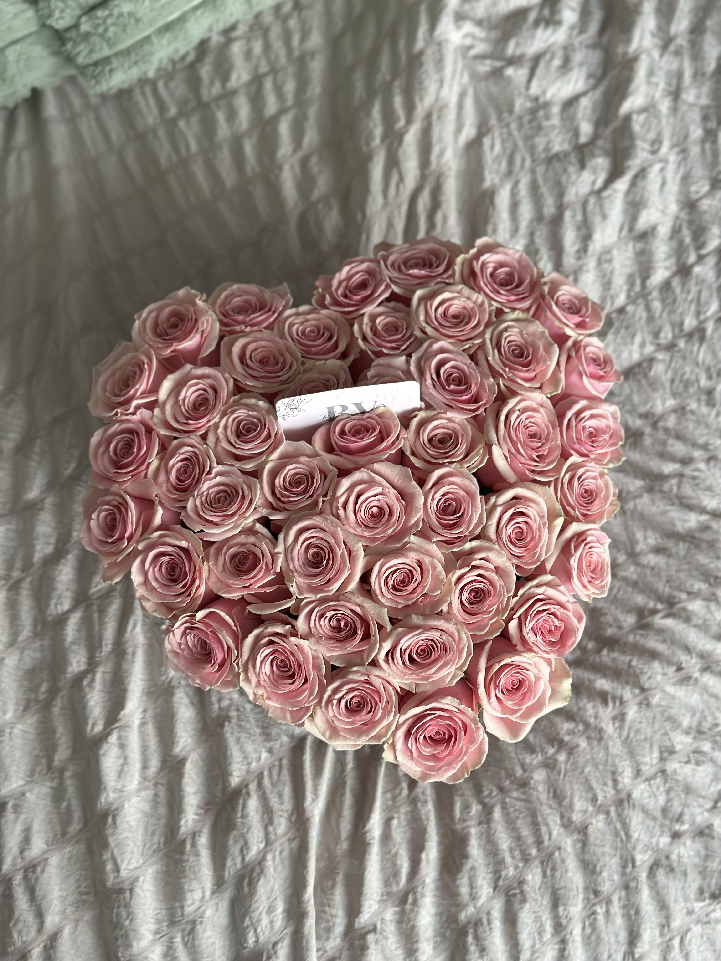 Coeur de Roses - A breathtaking heart-shaped arrangement of premium pink roses, designed to speak the language of love. Perfect for anniversaries, proposals, or any moment when words are not enough. Each bloom is carefully placed to create a symbol of tenderness and devotion.