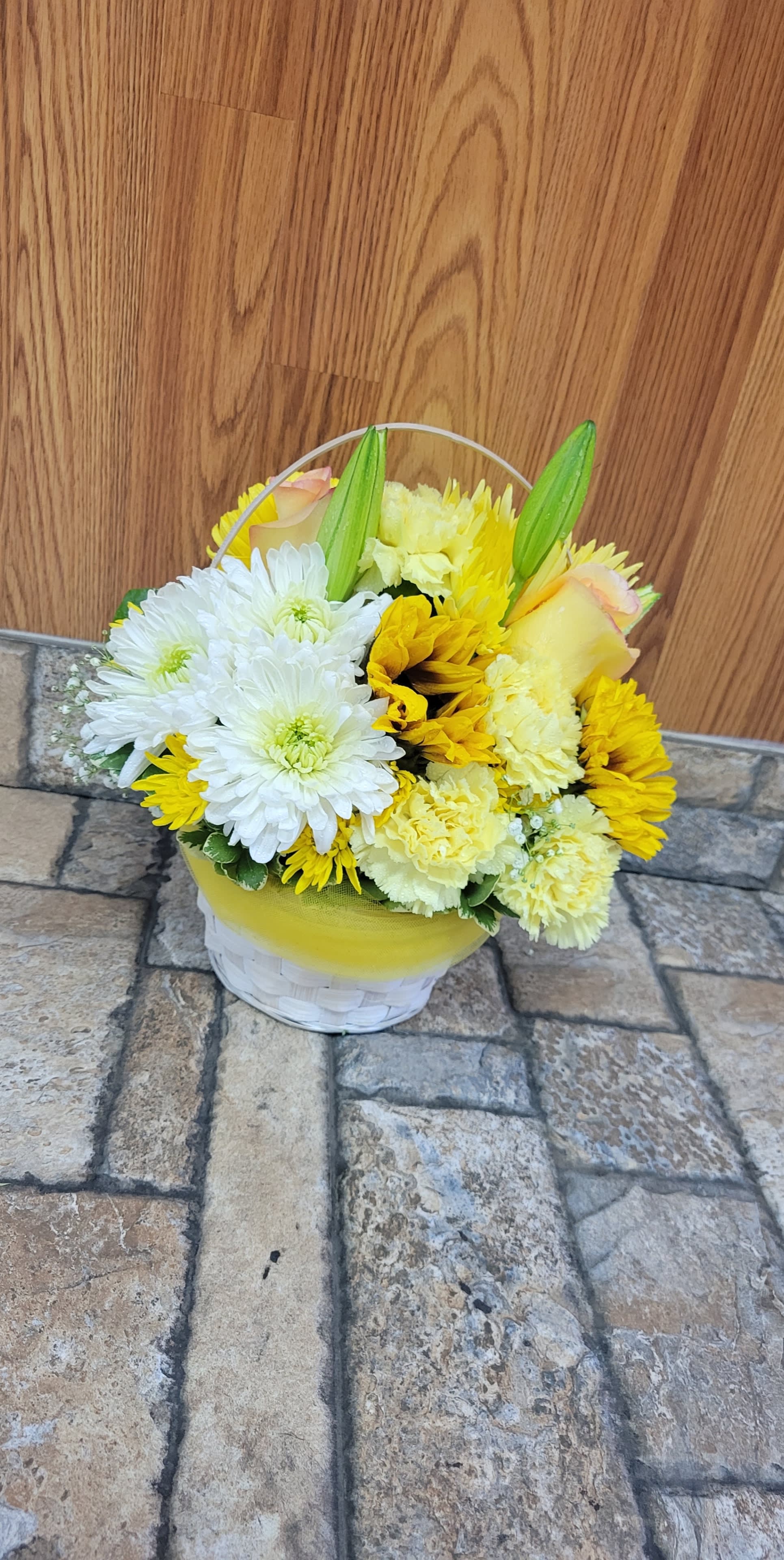 Walking on Sunshine Basket - A sunny basket is perfect for literally any occasion. Bright yellow and white flowers fill a reusable basket, wrapped with yellow tulle for that extra touch of sunshine. Brighten up someone's day today! The container may vary depending on availability. Bouquet may be sent in a basket, a metal or a plastic container.