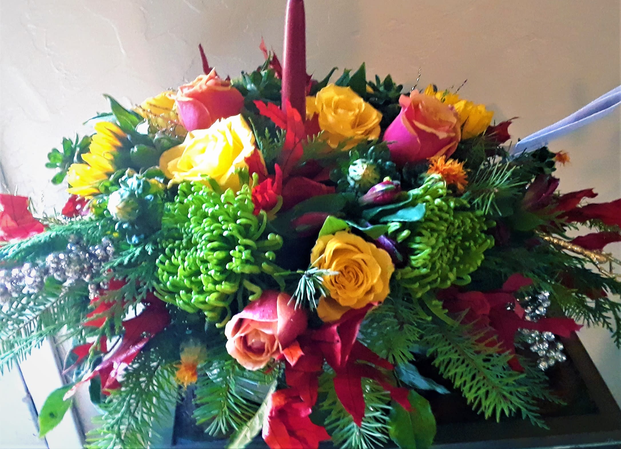 Thanksgiving centerpiece with candle. - Order this wonderful centerpiece with roses, pine greens, berries, fall leaves, other flowers, fine greens, sunflowers, and candle, for beautiful and festive gift. They will love it!