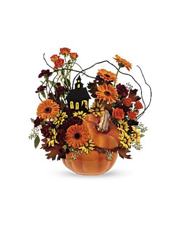 Haunted House Bouquet - What a boo-tiful way to get in the Halloween spirit! This lush mix of gerberas, carnations and daisies surrounds a spooky house in an adorable ceramic pumpkin jar - the perfect keepsake candy container and fall décor favorite for years to come! *This spooky arrangement includes orange gerberas, maroon miniature carnations, bronze daisy spray chrysanthemums, curly willow, seeded eucalyptus and brown transparent oak leaves. *Delivered in Teleflora's Fall Pumpkin container. *Orientation: One-Sided