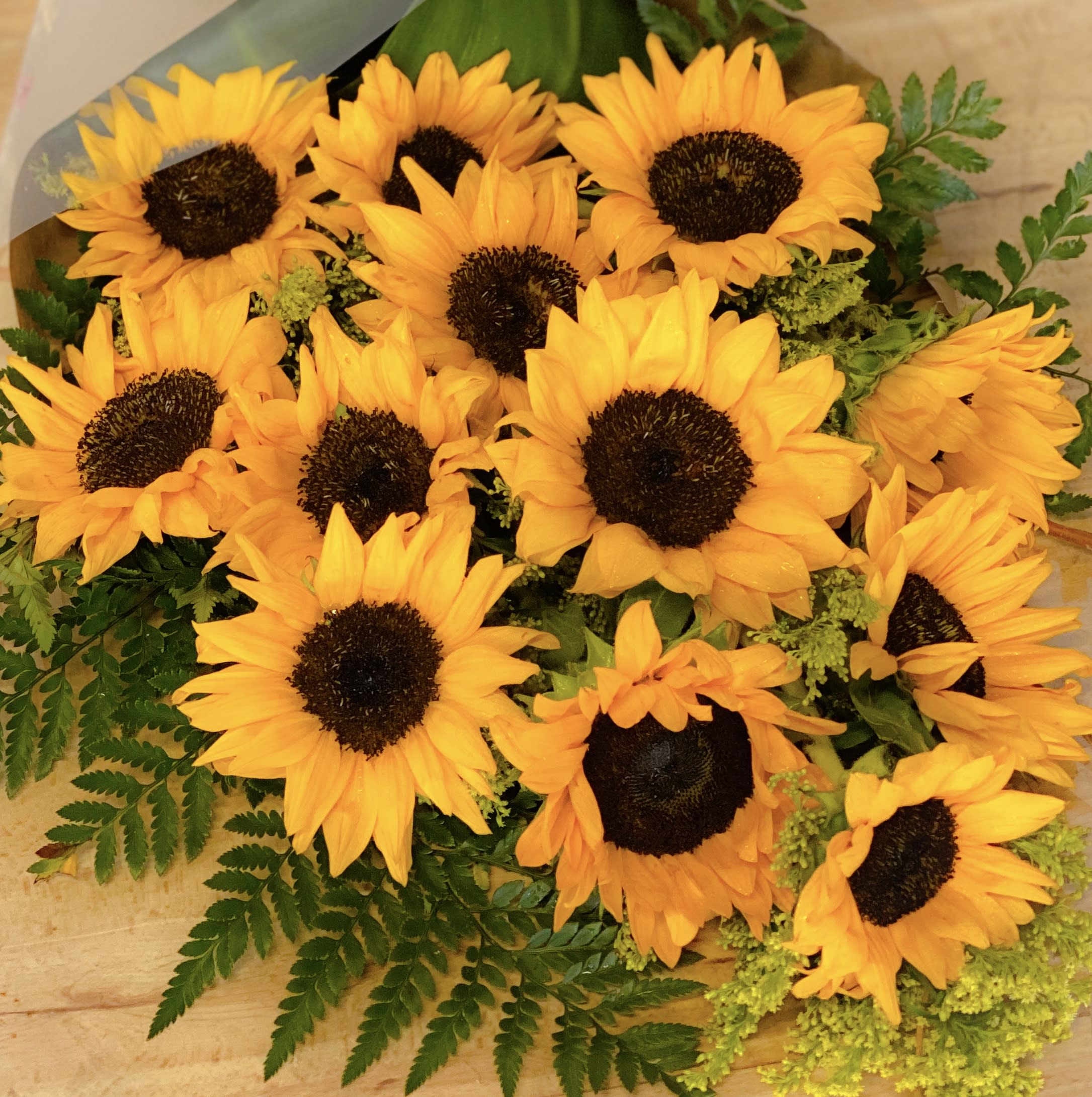 It’s A Dozen Sunflowers - A dozen of lush, fresh picked, best of the bunch, beautiful sunflowers elegantly wrapped with love! A gift to send smiles, create memories, a wonderful surprise or just because you remember. Perfect for all occasions under the sun, this bouquet will surely bring happiness to anyone and everyone! Order for same day delivery today!  Accented with curly willows, rose petals and solidago.  Approximately 28” H x 14” W