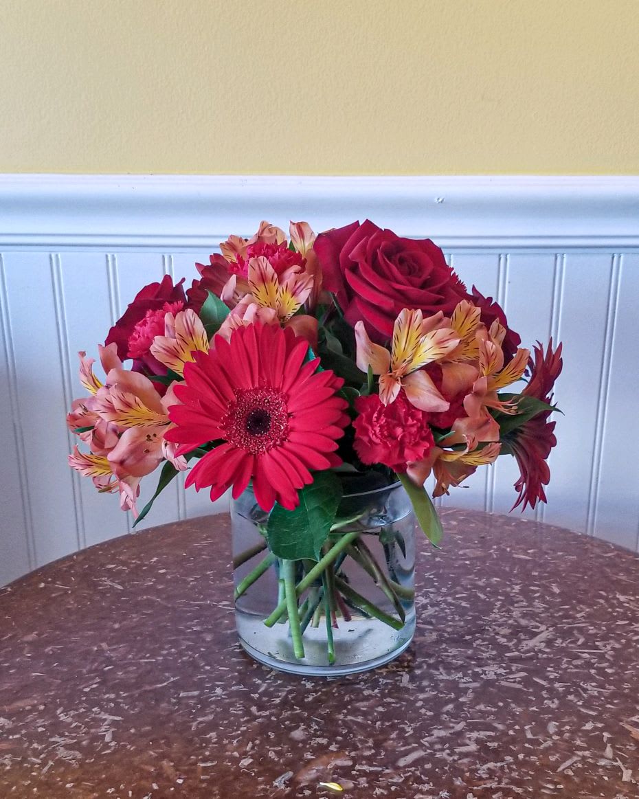 Cinnamon Spice - This cinnamon-colored arrangement is a perfect taste of fall. Perfect for any occasion in the fall season, it features red gerbera daisies and yellow alstroemeria.  Approximate Dimensions: 11&quot;D x 11&quot;H