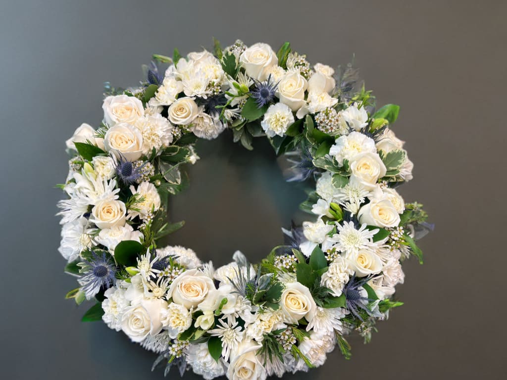 Serenity Wreath by Teleflora Serenity Wreath by Teleflora - A ring of fragrant, bright white blossoms will create a serene display at any funeral or wake. This classic wreath is delivered on an easel, and is a thoughtful expression of sympathy and admiration.