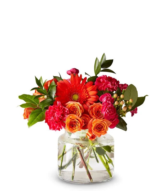 Spice It Up - Sweet and serene, let all your cares drift away into this Tangerine Dreams bouquet. This stunning collection of bold orange and pink toned blooms is bursting from a modern cinched vase. This vibrant floral piece is perfect for wishing friends and loved ones a Happy Birthday, reminding them that they are loved, or cheering up a neighbor who is struggling. 