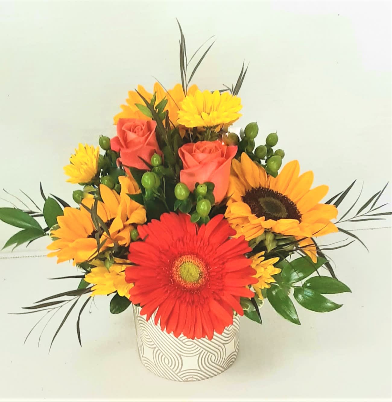 Sweet Fall Wishes - Sunflowers ,roses, daisies ,and berries with a bright fall Gerbera is just the right touch for an office desktop. Displayed in a white and brown swirl ceramic container. Approximately 7&quot; wide by 10&quot; tall.