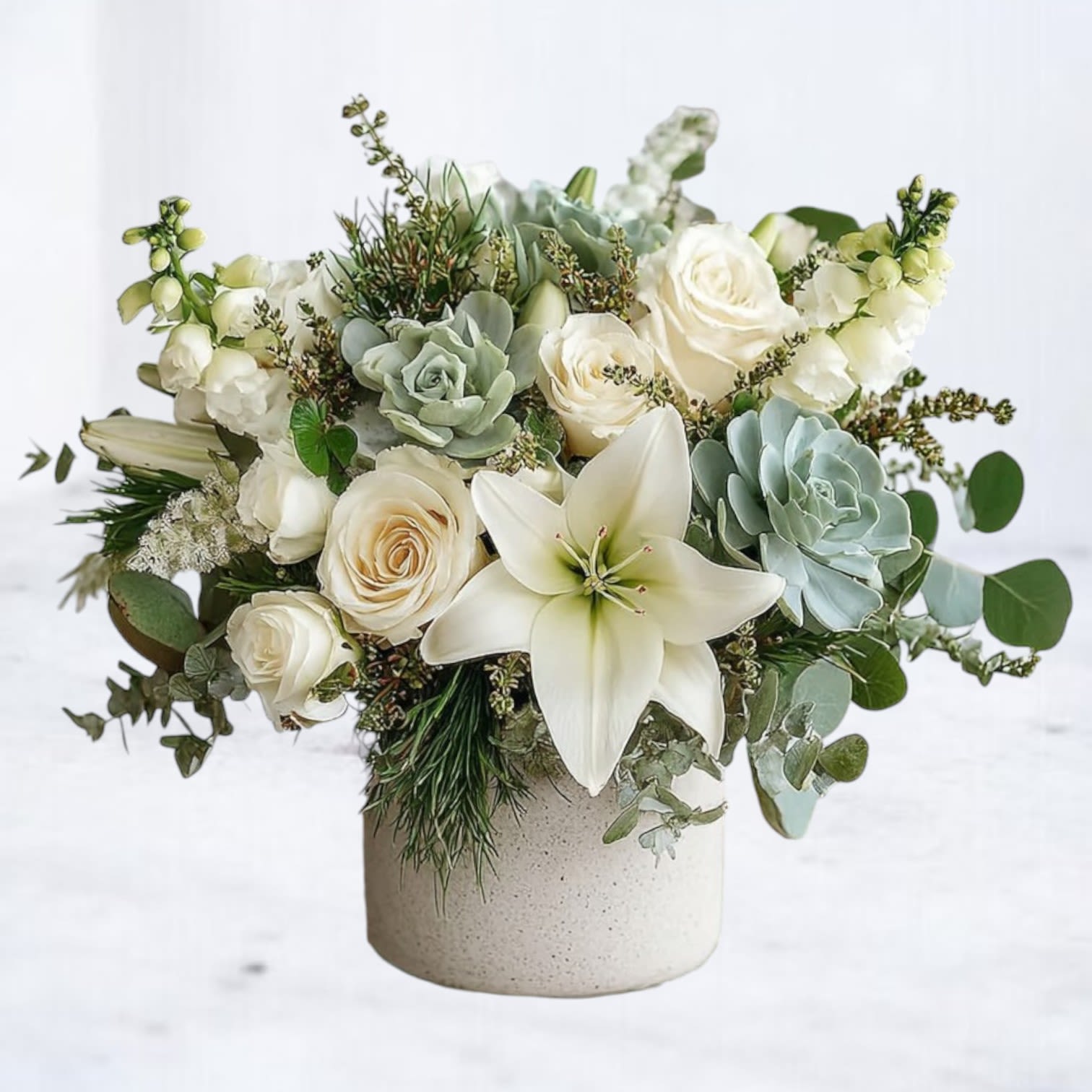 Evergreen Serenity Evergreen Serenity - The Evergreen Serenity Bouquet offers a peaceful balance of timeless elegance and modern comfort. Featuring creamy white roses, lilies, and snapdragons paired with lush succulents and textured greenery, this arrangement is thoughtfully designed in a natural stone-style vase. Its soft, serene palette conveys compassion, remembrance, and enduring love. Perfect for sending condolences, honoring a loved one, or bringing quiet comfort to the home, this sympathy bouquet is a meaningful gesture of support during difficult times. Available for same-day flower delivery in Magnolia, The Woodlands, Spring, Montgomery, and surrounding Houston areas.