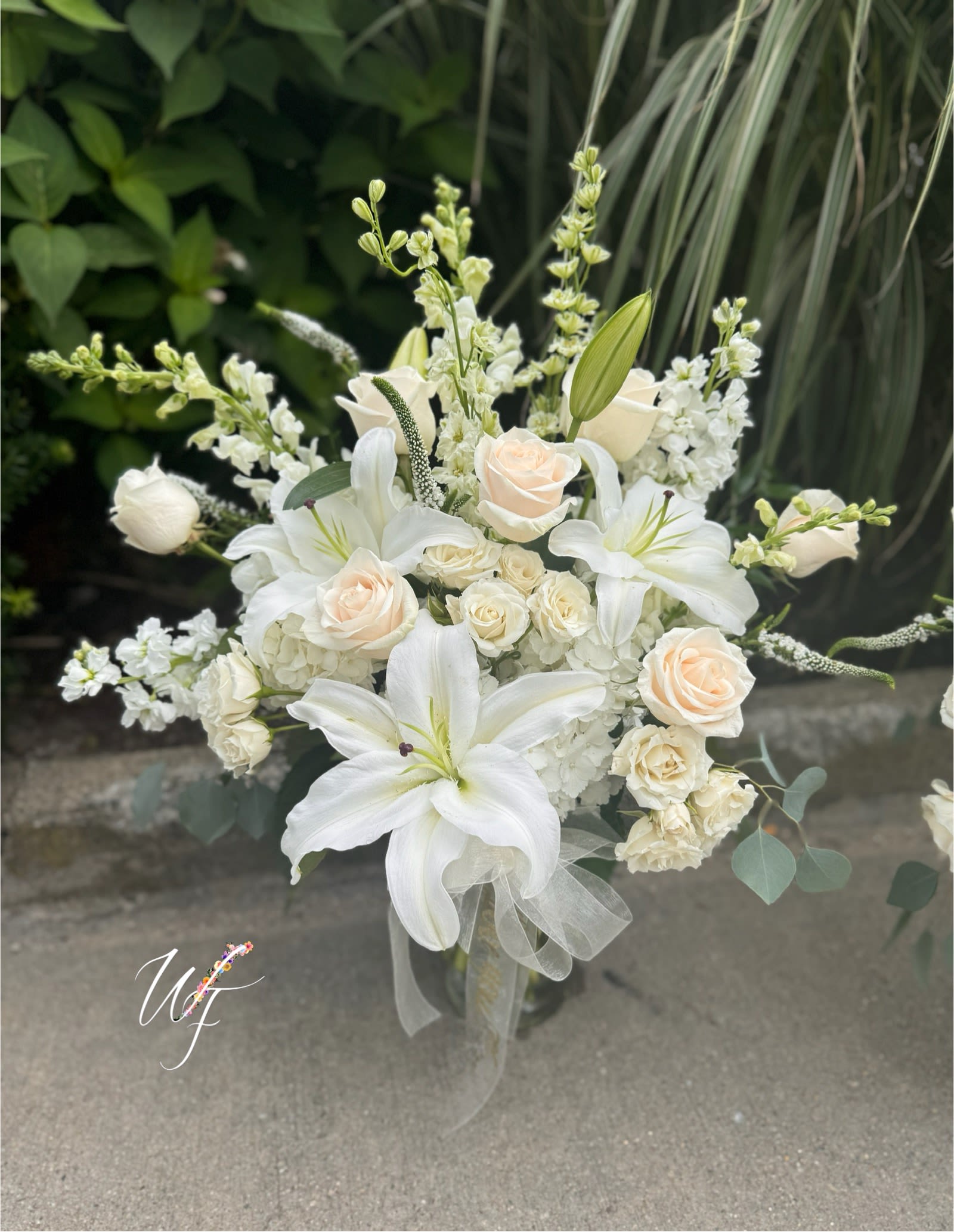 Garden of memories  - Whites and creams softly speak in this tall garden style arrangement 