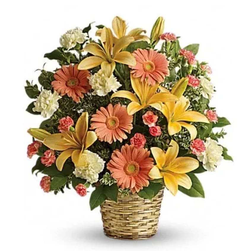 Soft Sentiments Bouquet - Bring warmth to the memorial service or home with this basket of sunshine. A radiant tribute to a bright, beautiful life, this bouquet of lilies, gerberas and carnations is a comforting reminder of your support and affection. This sentimental favorite features peach asiatic lilies, peach gerberas, crÃ¨me carnations and minature orange carnations with fresh green oregonia and lemon leaf. Deilvered in a natural woven basket.