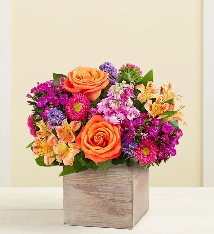 Splendid Beauty™ Bouquet - Capture spring’s vibrant beauty with our splendid bouquet. Hot pink, orange and purple blooms are gathered with lush greenery in our rustic, gray-washed wooden cube for a gift that conveys your feelings in the most wonderful way.