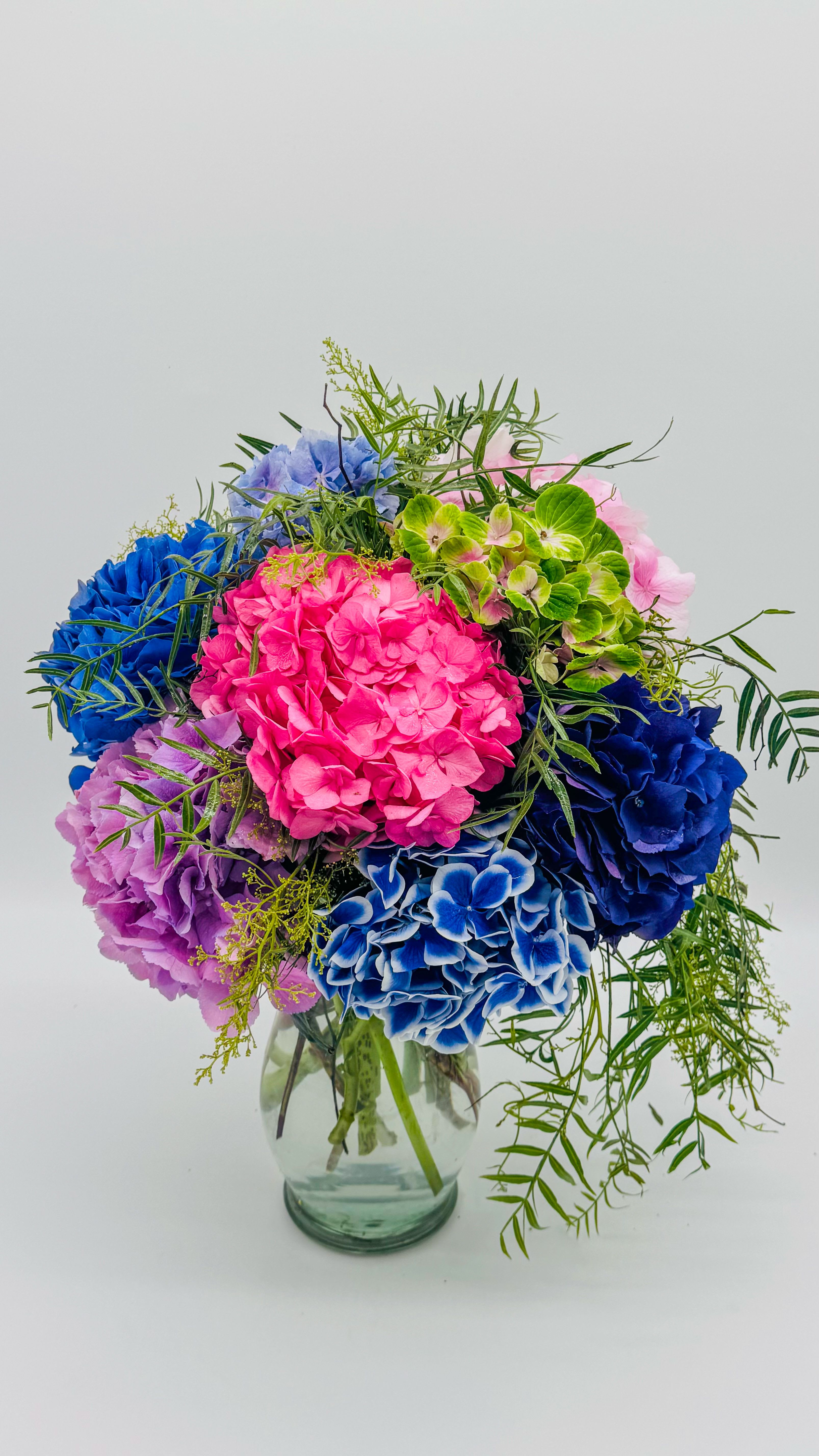 Rainbow Bloom Hydrangeas - A stunning arrangement of premium hydrangeas in a vibrant array of colors, showcasing their natural beauty and long-lasting elegance. Perfect for brightening any space with a touch of color and sophistication.
