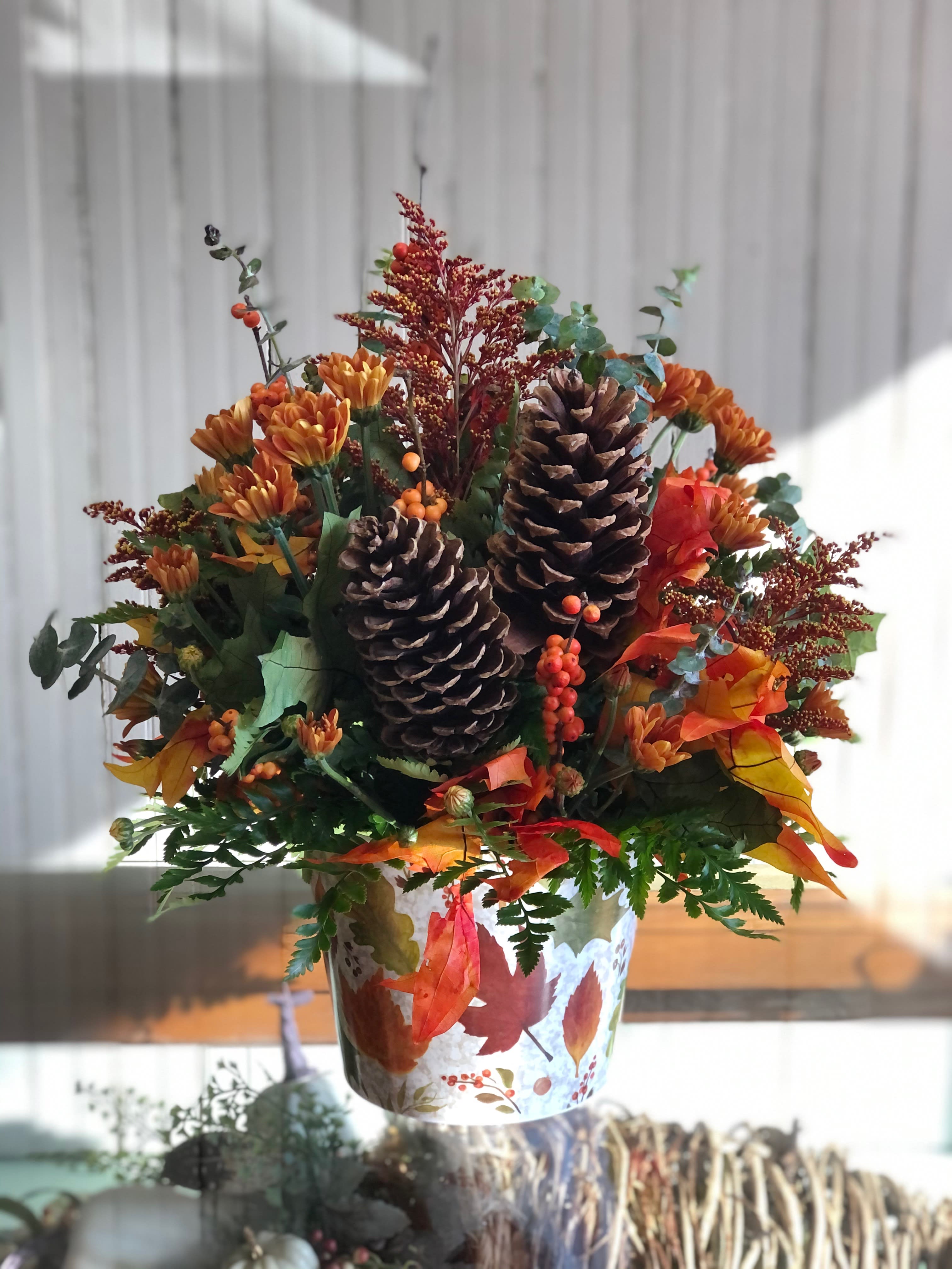 Fall Foliages - A decorative container filled with foliage of Autumn.   ****We will try our best to match the flowers in the picture, but there may be times when we substitute flowers. We will always try to make it have the same look and feel as the original.