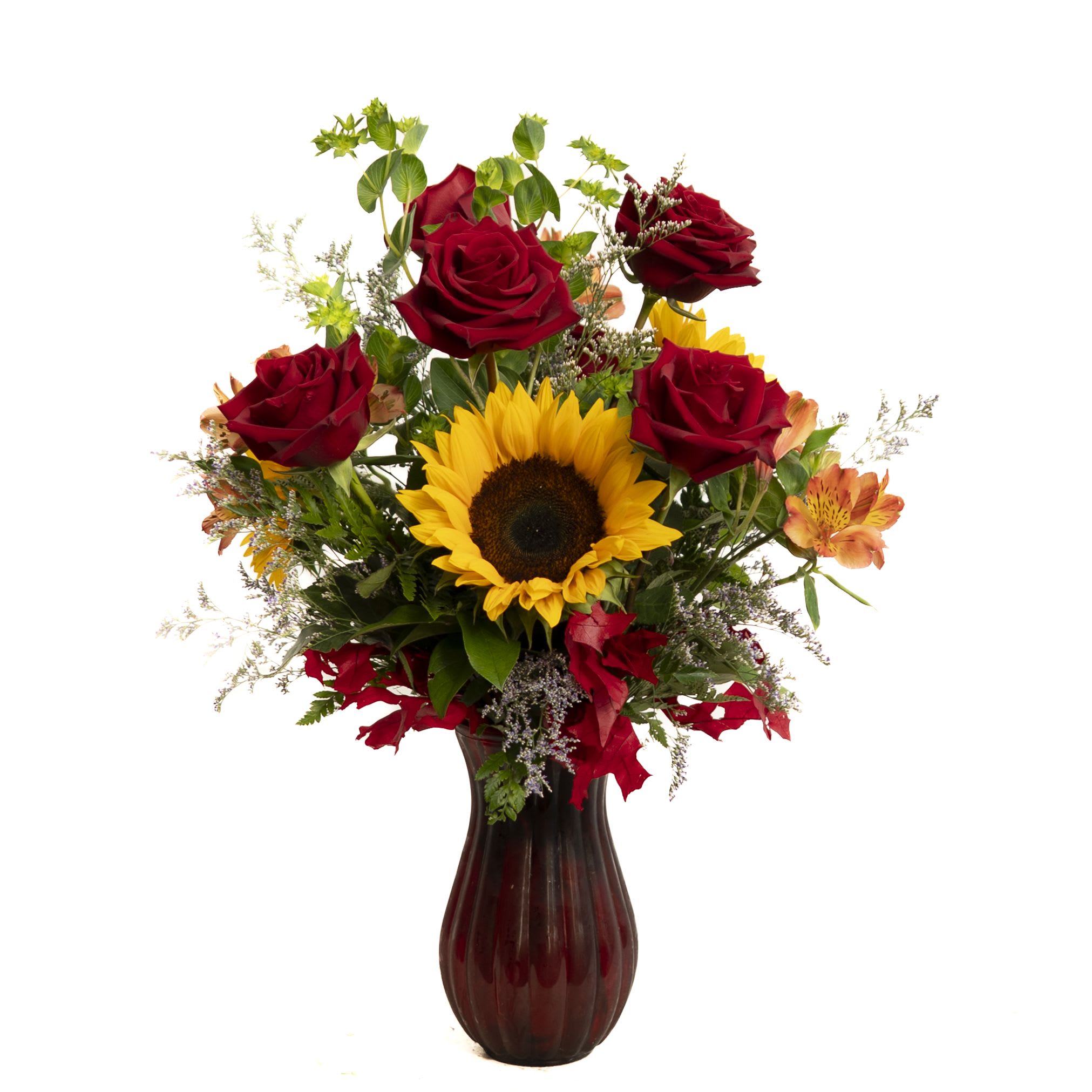 Fall Allure (Red vase) Fall Allure (Red vase) - This rich red glass vase is home to Sunflower, red Roses, preserved fall leaves, Limonium and Bluplureum.
