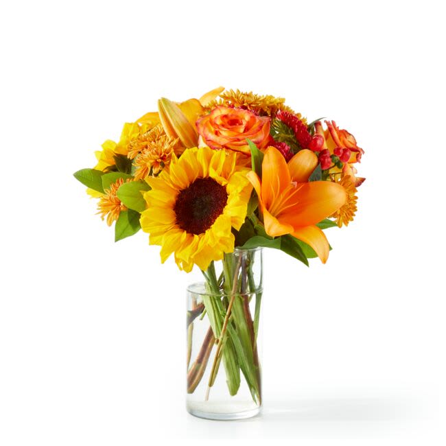 Fall Day Bouquet (FTD) - Capturing the beauty of the season, this arrangement brings all the warmest tones of Fall with its beautiful sunflowers, roses and lilies! Approximately 11 inches wide and 14 inches tall for the Standard size.