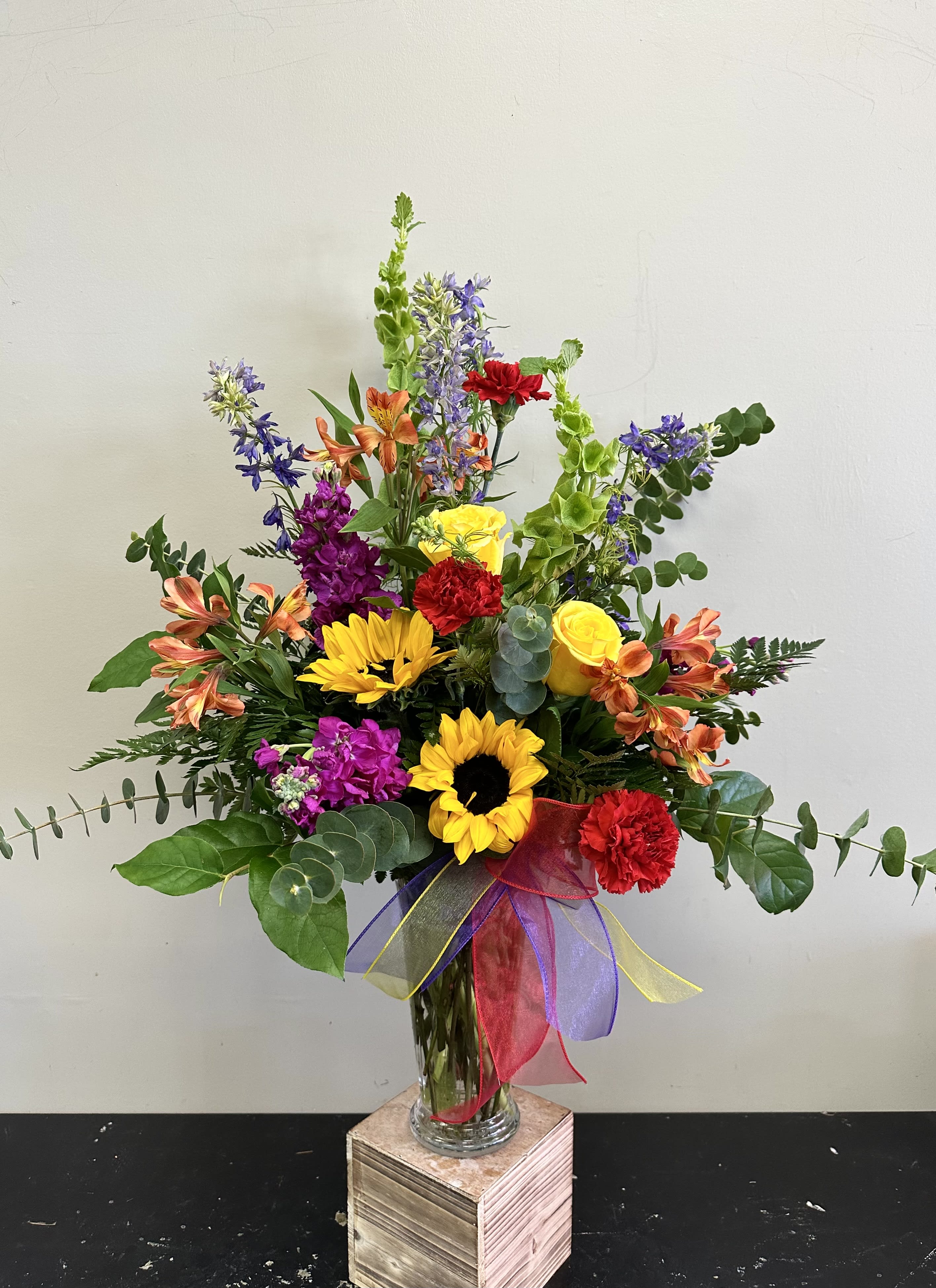 Sunshine Sunshine - The perfect bright floral arrangement filled with sunflowers, stock, larkspur, alstroemeria and carnations!  This is a one sided arrangement.