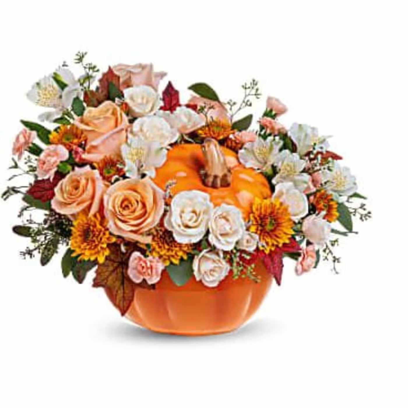 Classic Pumpkin - The arrangement features a variety of autumn-themed flowers in classic creams, peach and butterscotch's and greenery artfully arrangement in a ceramic keepsake pumpkin.  